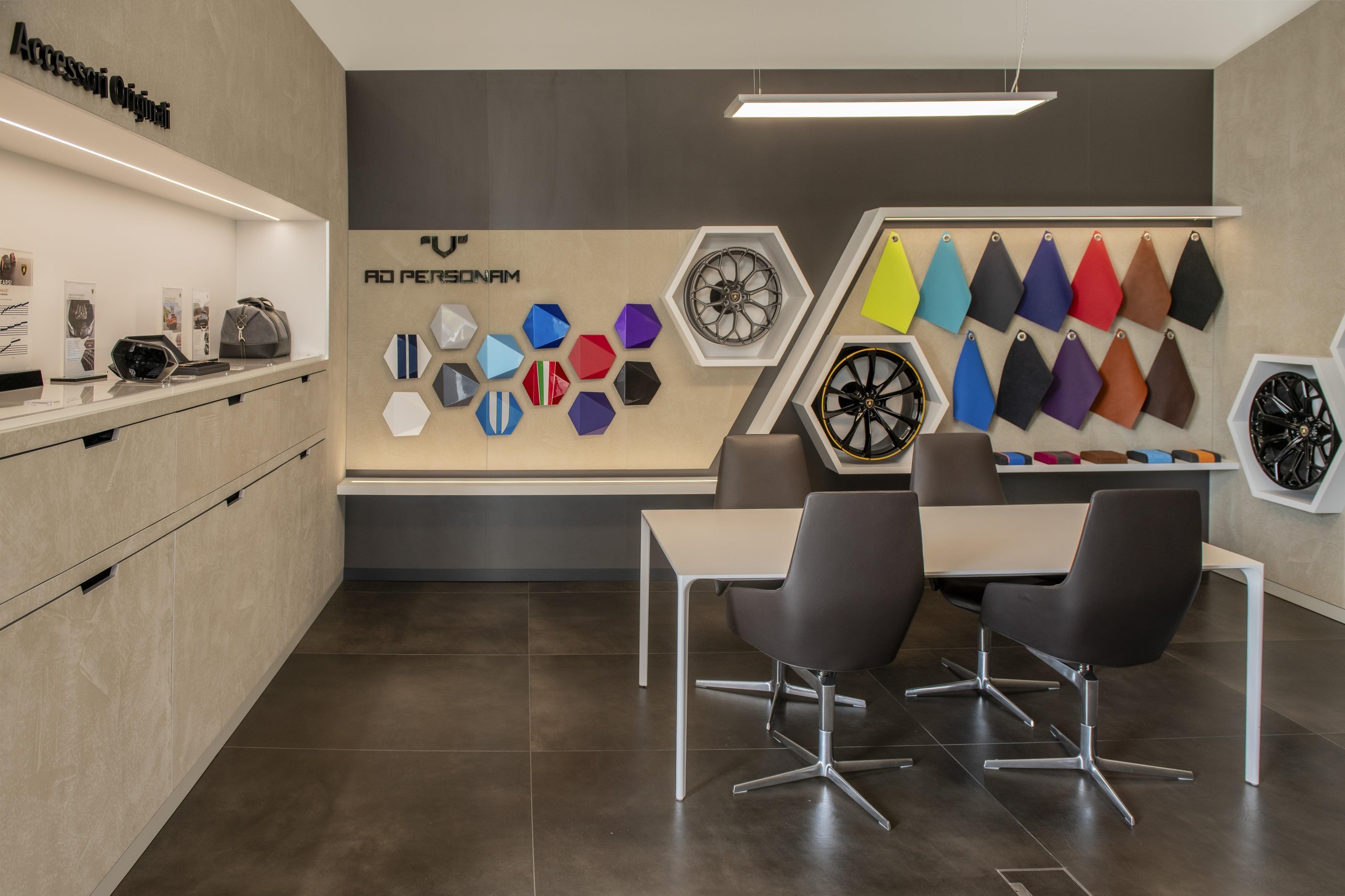 Budapest Gets Its First Lamborghini Showroom, And The Revuelto Came Along To Make The Point 9 Wide view of the lamborghini ad personam customization studio in budapest with material samples, wheel displays, and consultation table