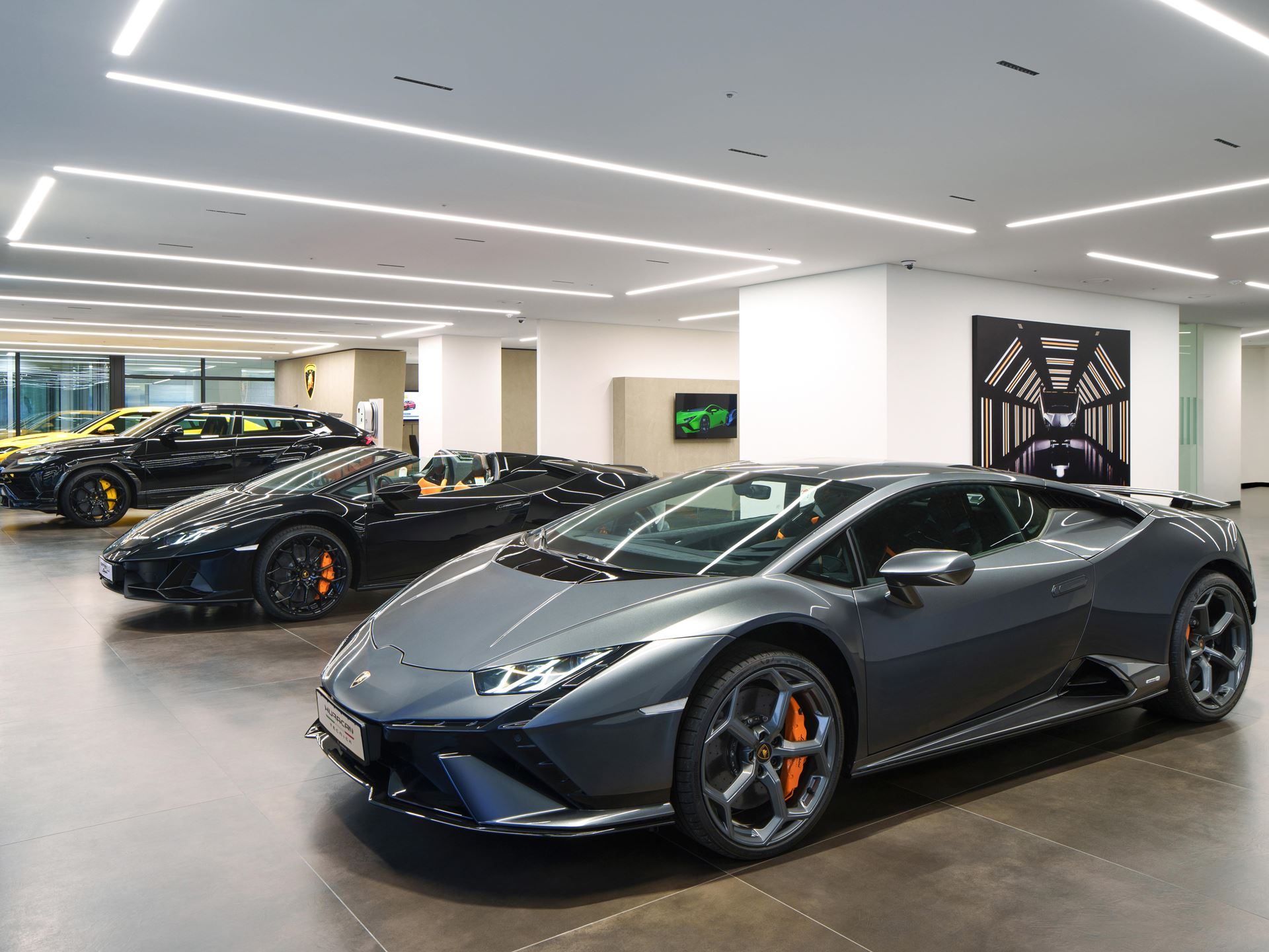 Lamborghini Bundang Puts The Urus Se On Stage For South Korea'S Tech Corridor 9 A grey lamborghini huracán in the foreground of the bundang showroom with a black huracán spyder and yellow urus visible behind it
