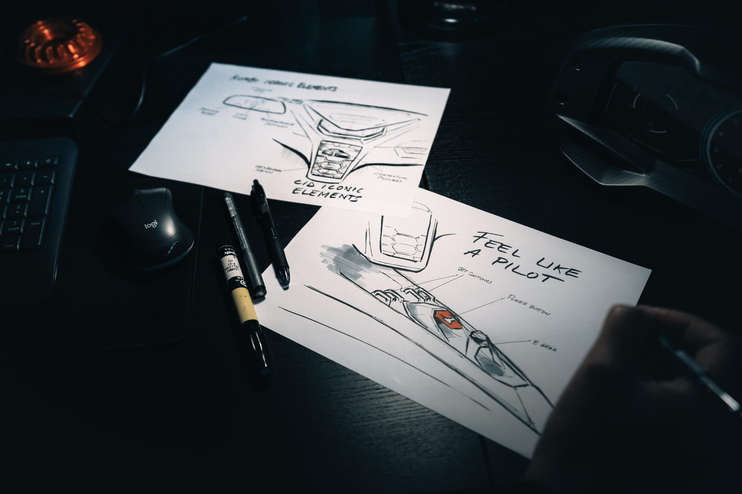 Close-up of Lamborghini interior design sketches featuring hexagonal motifs and 'Feel Like a Pilot' text