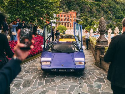 How The Countach Became The Wall That Launched A Thousand Obsessions 2 Purple lamborghini countach lp 400 with scissor doors open on a stone path surrounded by spectators at villa d'este