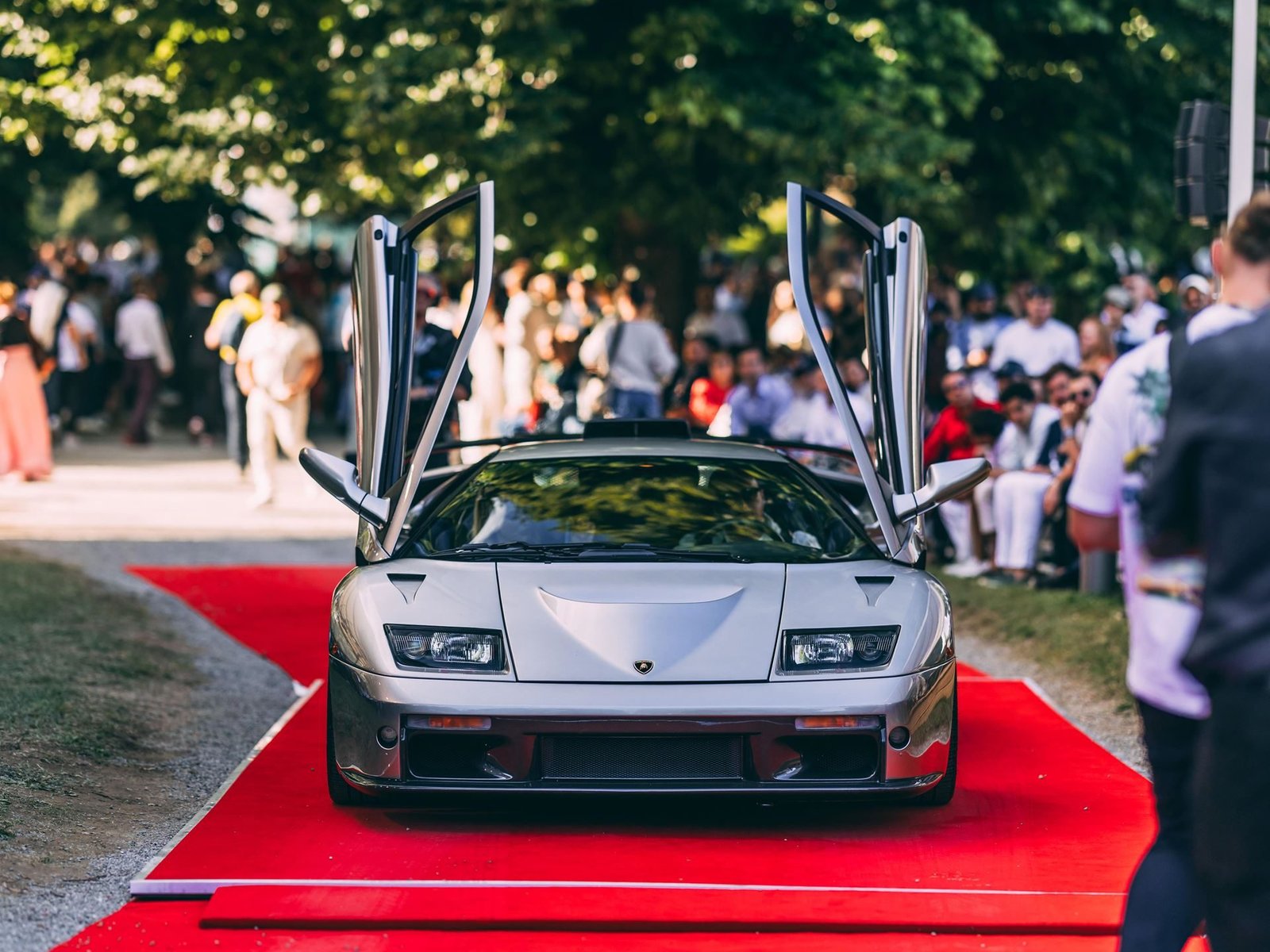 Silver Lamborghini Diablo GT with scissor doors open on the red carpet at the 2024 Concorso d'Eleganza Villa d'Este