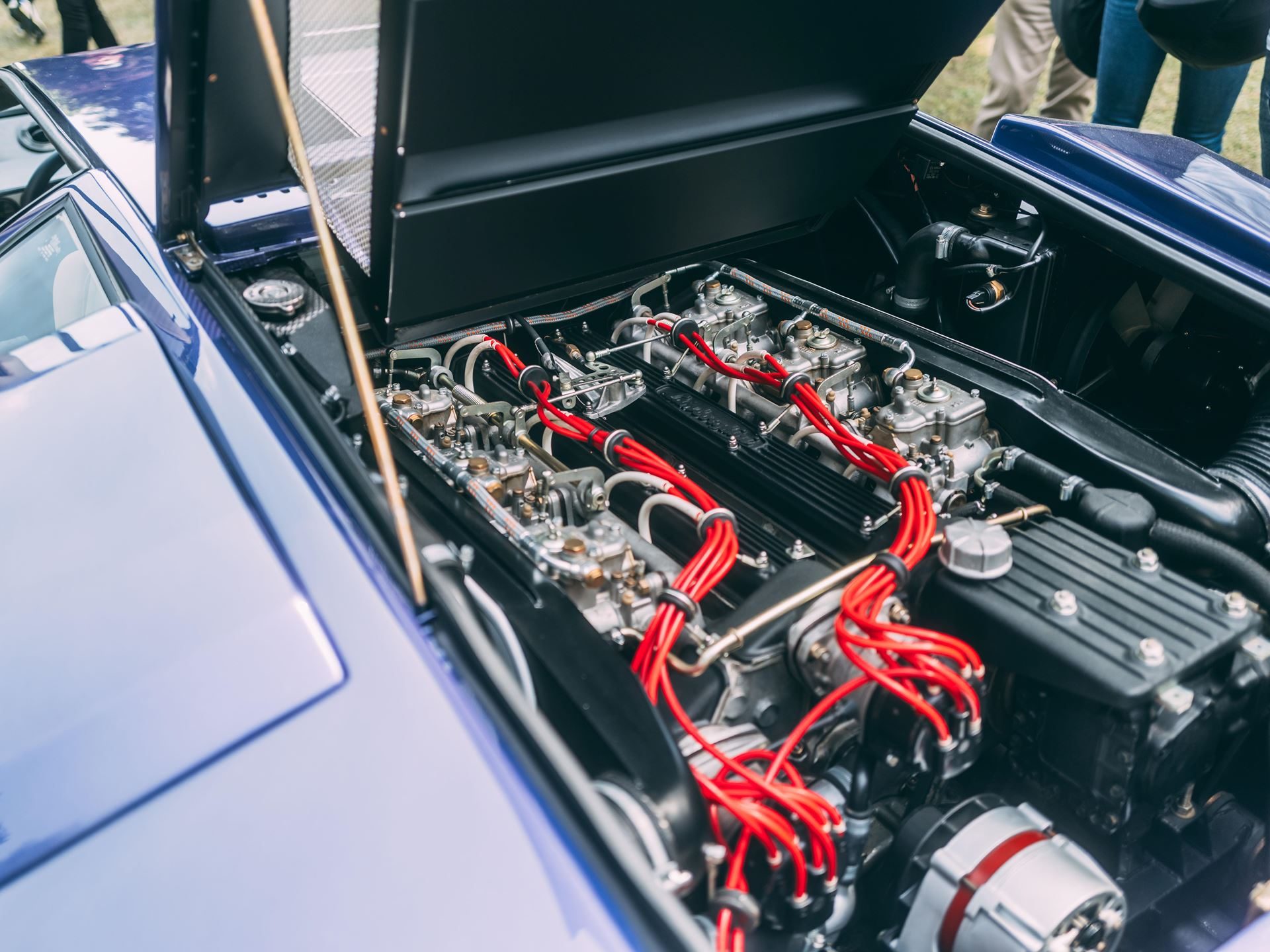 Two Trophies, Four V12S: Lamborghini'S Strongest Villa D'Este Showing In Years 9 Exposed v12 engine bay of the blue lamborghini countach lp 400 showing red ignition wires and carburetors