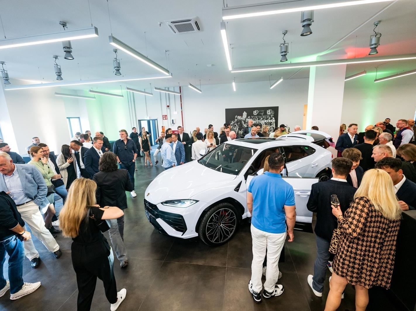 Lamborghini'S New Cologne Showroom Puts The Urus Se Center Stage For Germany'S Hybrid Era 3 White lamborghini urus se displayed inside the new cologne showroom surrounded by guests at the opening event