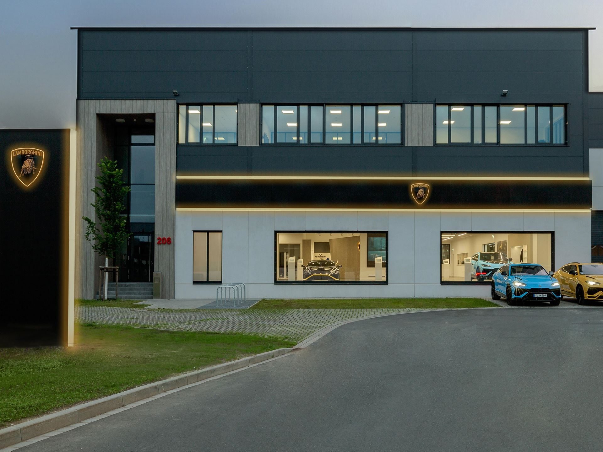 Lamborghini'S New Cologne Showroom Puts The Urus Se Center Stage For Germany'S Hybrid Era 9 Lamborghini cologne dealership exterior at dusk with illuminated branding and several lamborghini vehicles parked outside