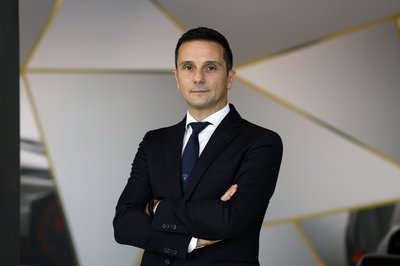 Lamborghini'S New Procurement Chief Built Polo Storico. Now He Sources Parts For The Electric Era. 2 Paolo gabrielli, new chief procurement officer at automobili lamborghini, standing with arms crossed against a modern geometric background