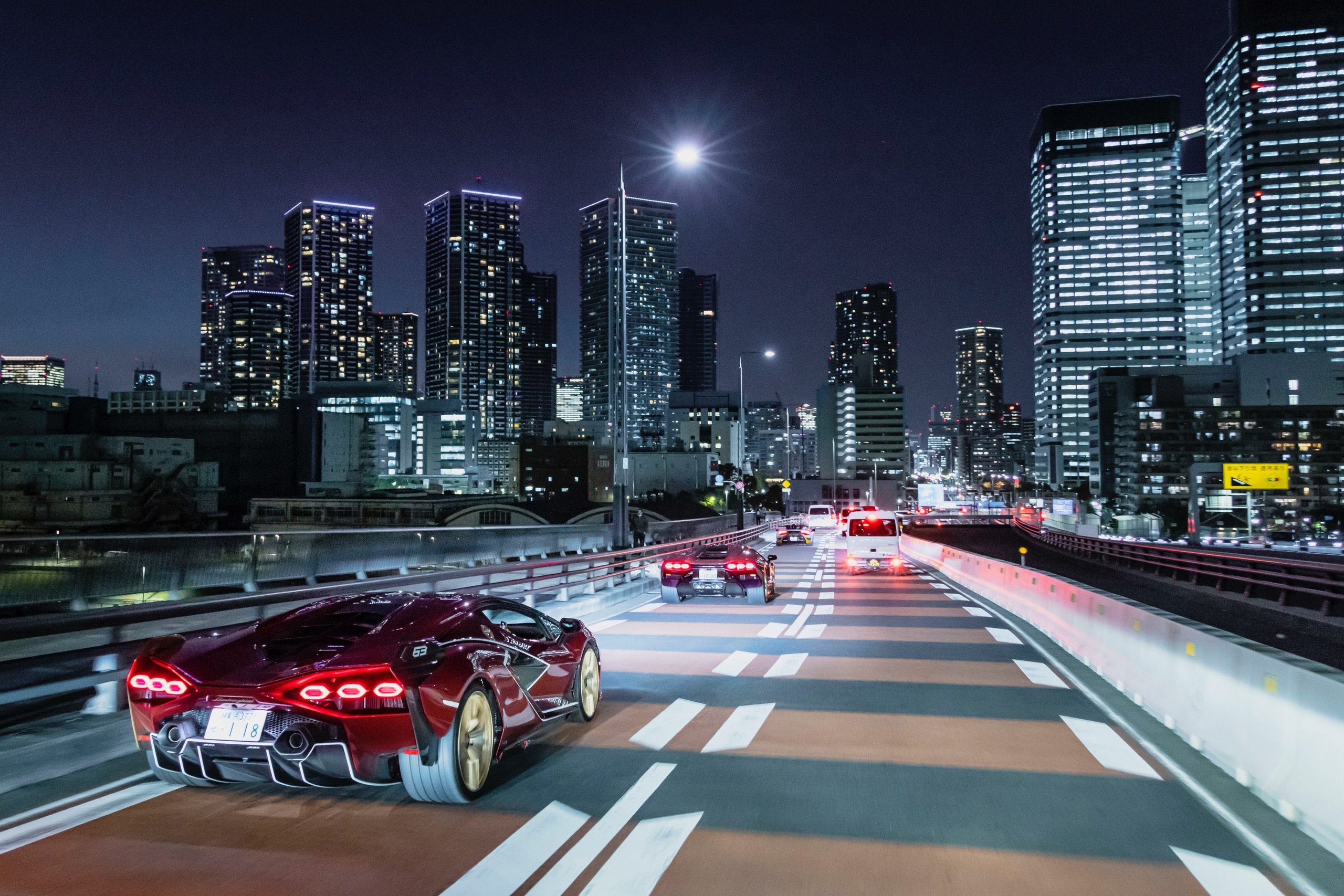 180 Lamborghinis Took Over Tokyo: What Lamborghini Day Japan 2022 Reveals About The Brand'S Asian Strategy 5 Red lamborghini sián fkp 37 driving on a multi-lane tokyo highway at night with illuminated skyscrapers