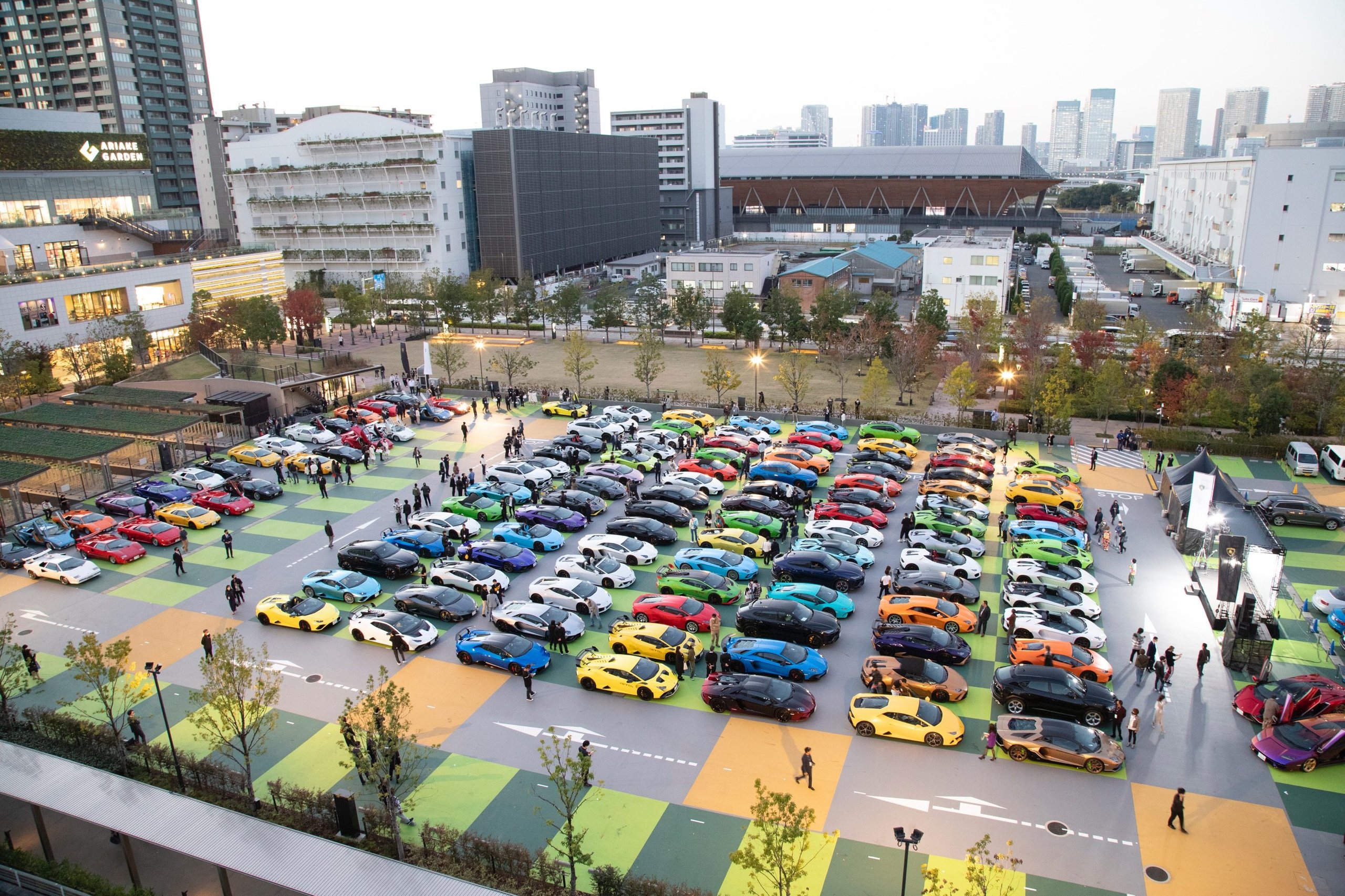180 Lamborghinis Took Over Tokyo: What Lamborghini Day Japan 2022 Reveals About The Brand'S Asian Strategy 3 Aerial view of approximately 180 lamborghini cars of various models and colors arranged outdoors at lamborghini day japan 2022