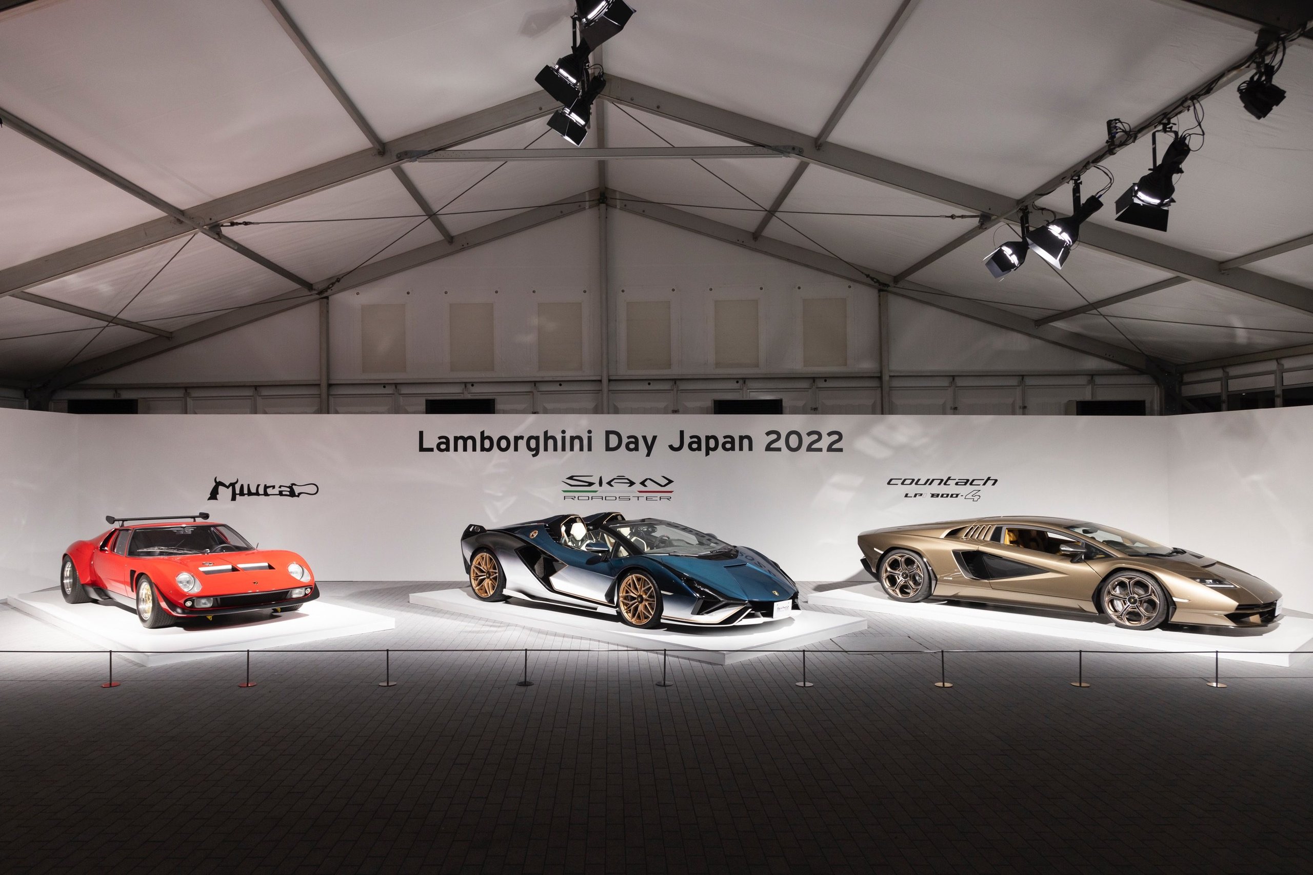 180 Lamborghinis Took Over Tokyo: What Lamborghini Day Japan 2022 Reveals About The Brand'S Asian Strategy 9 Red miura, blue sián roadster, and gold countach lpi 800-4 displayed under spotlights at lamborghini day japan 2022