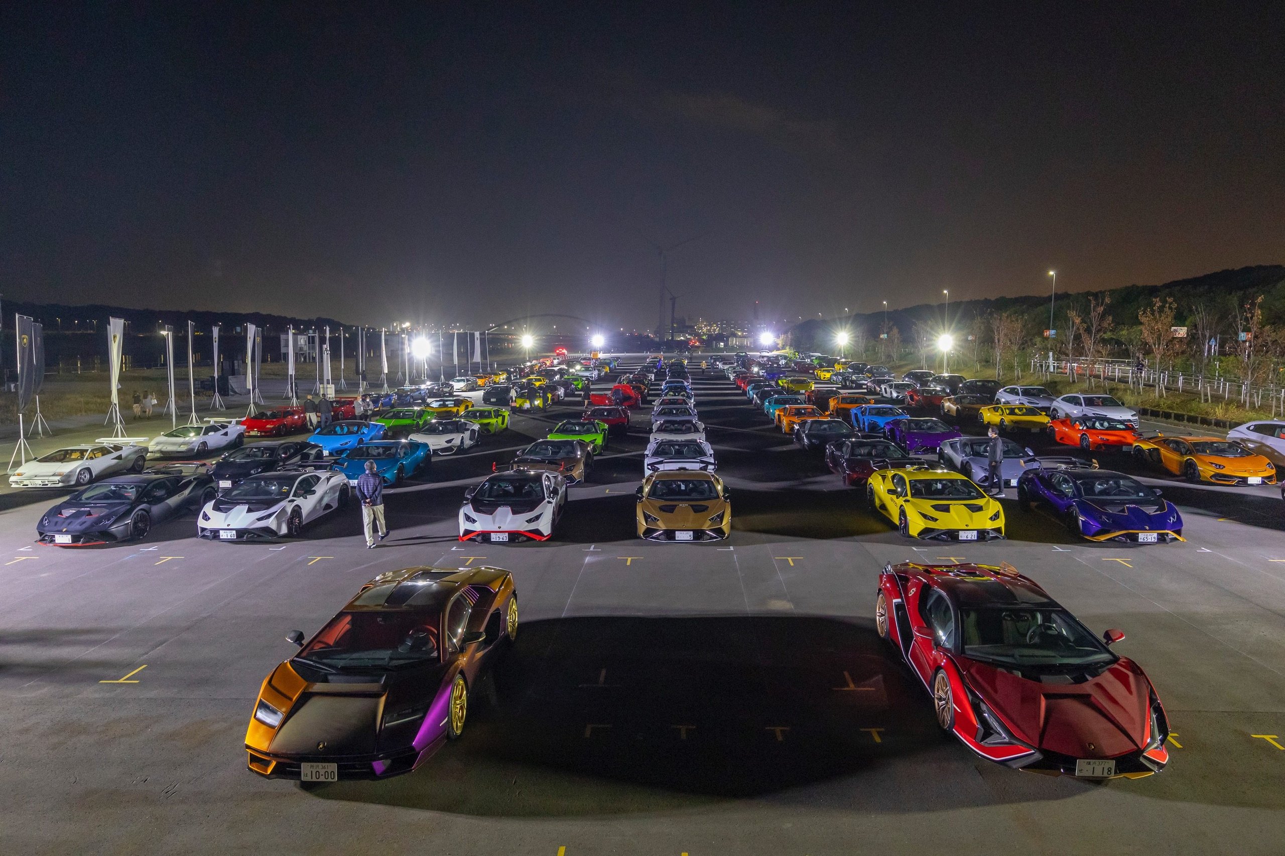 180 Lamborghinis Took Over Tokyo: What Lamborghini Day Japan 2022 Reveals About The Brand'S Asian Strategy 13 Aerial night view of lamborghini cars arranged outdoors at sea forest waterway with distant tokyo city lights