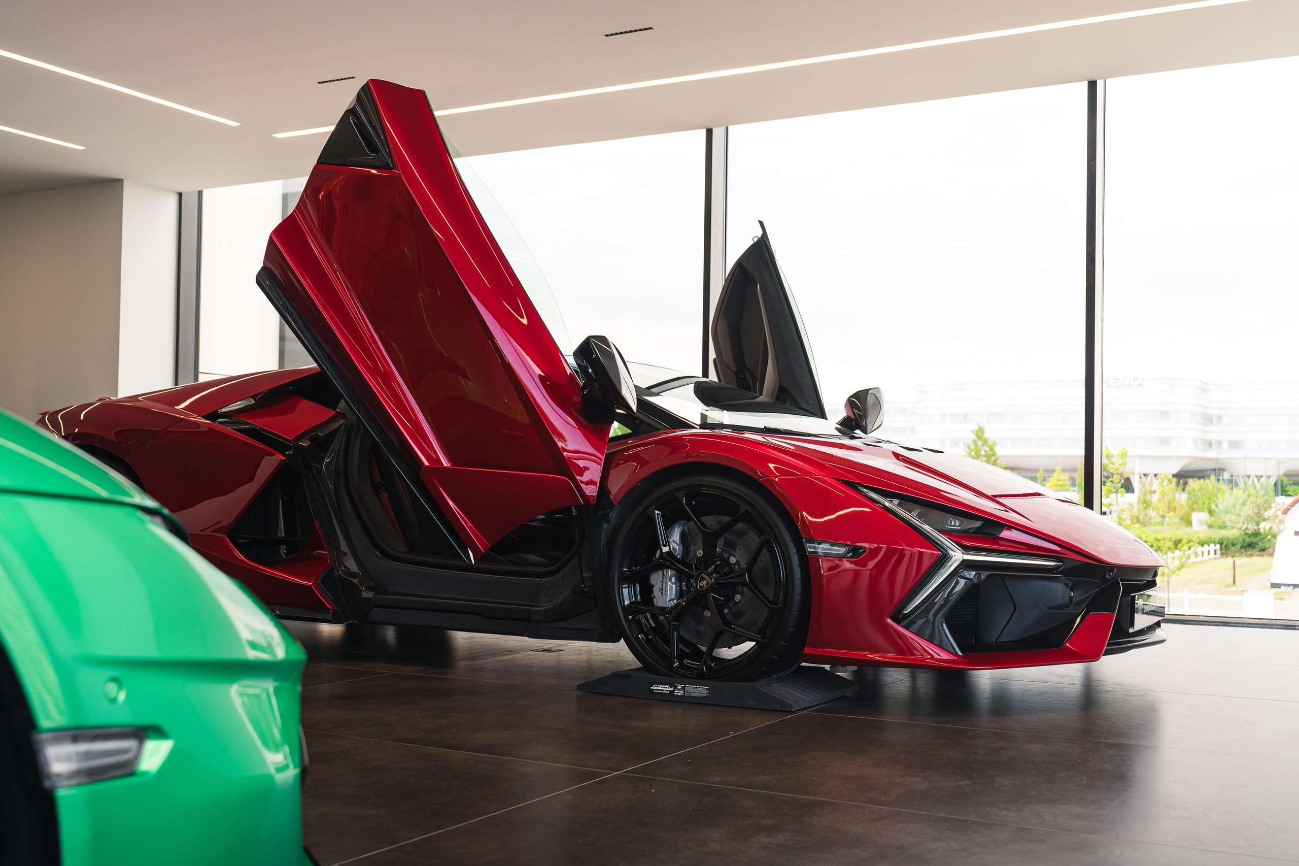 Lamborghini Plants Its Flag On Belgium'S Wealthiest Coastline With A New Knokke Showroom 7 A red lamborghini revuelto with scissor doors open displayed in the bright knokke showroom