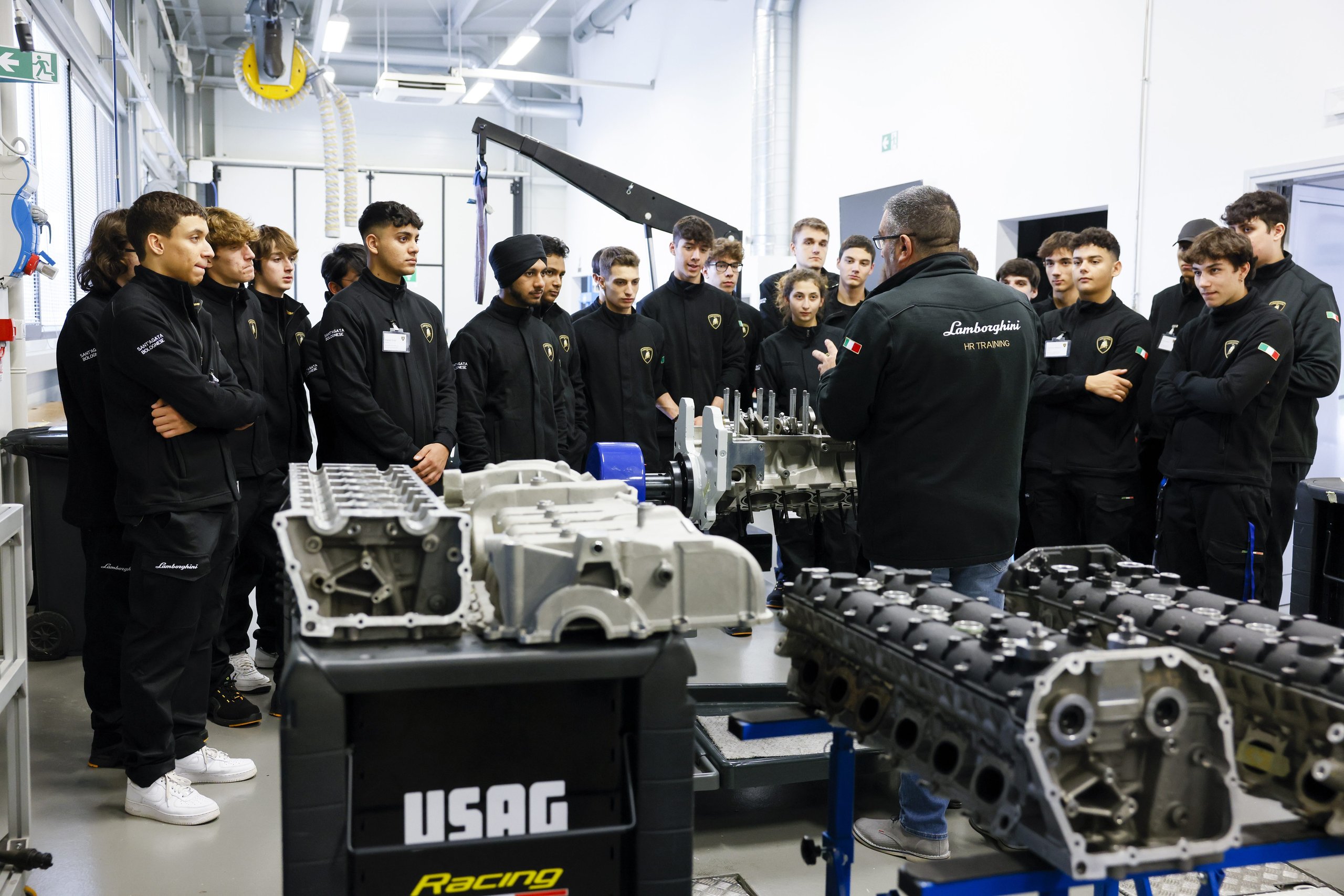 Inside Lamborghini'S Desi Program, Where 24 Students Train To Build Supercars 9 Instructor and students examining engine components during hands-on workshop training at lamborghini's facility