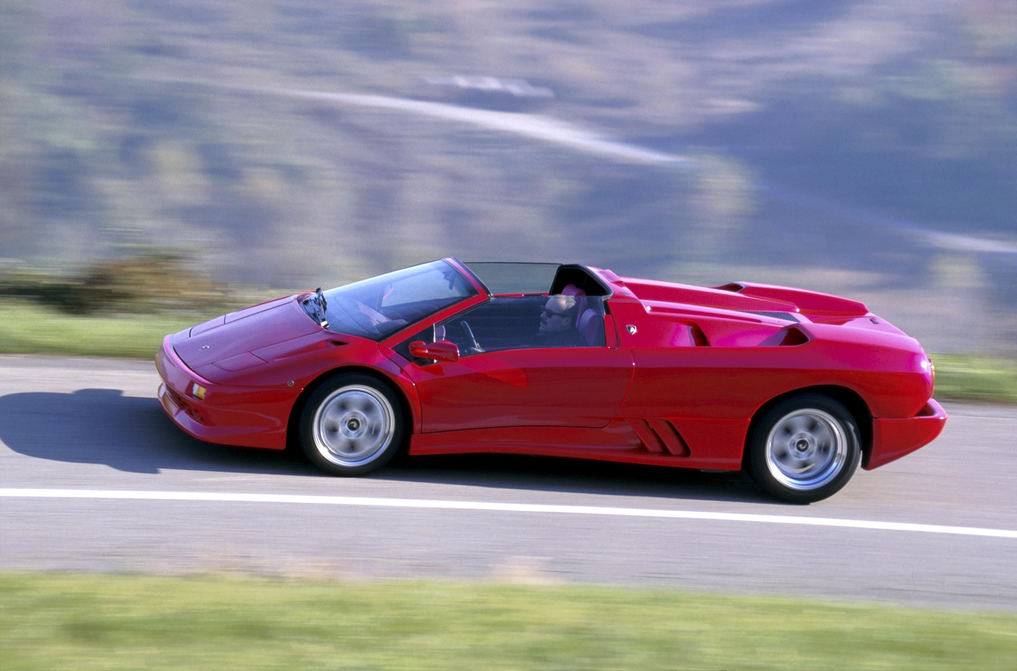 Lamborghini Diablo At 35: How The 1990S Speed King Built The Brand We Know Today 9 Red lamborghini diablo roadster in motion on a winding road with blurred background indicating speed