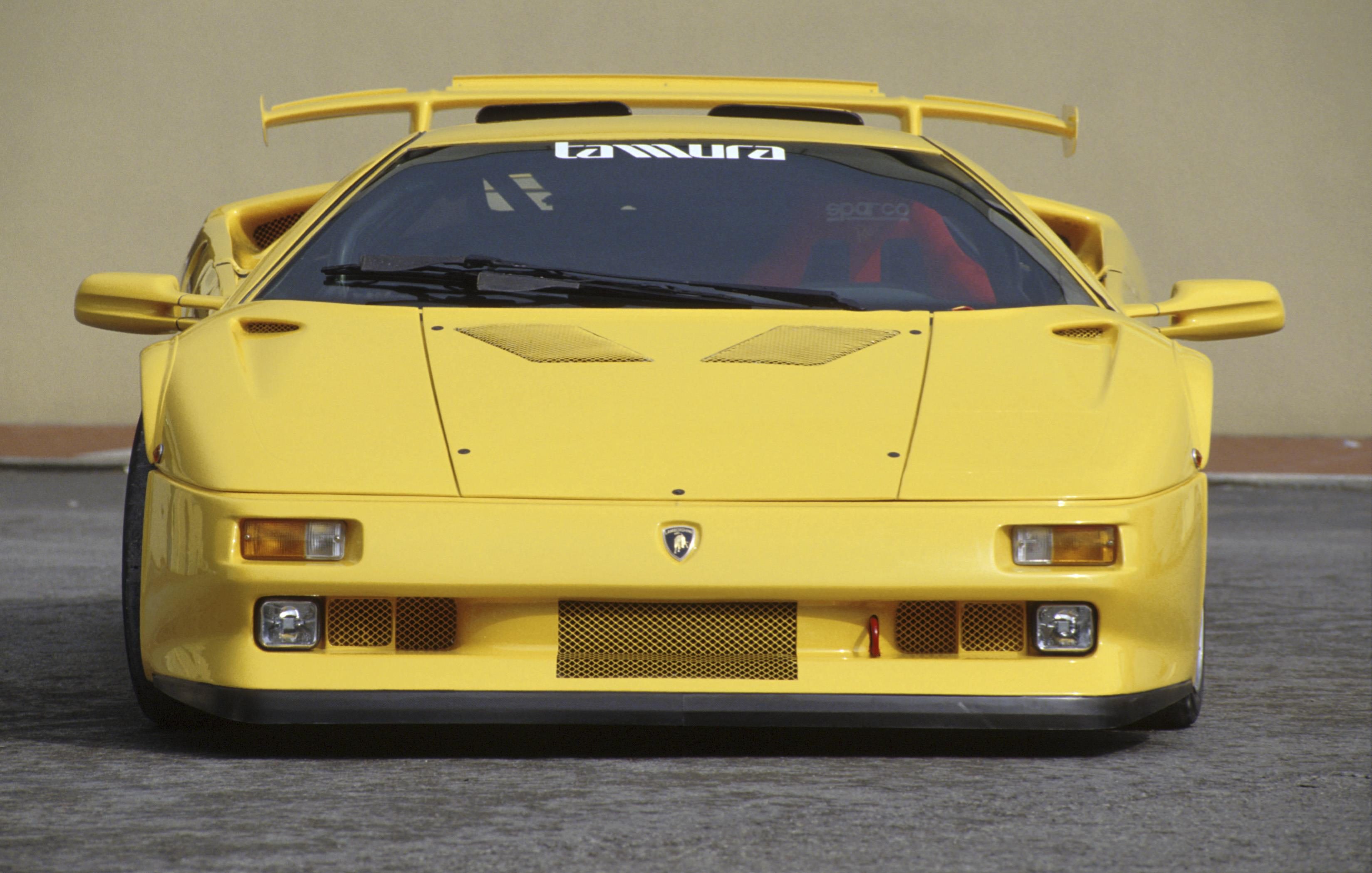 Lamborghini Diablo At 35: How The 1990S Speed King Built The Brand We Know Today 19 Head-on close-up of a yellow lamborghini diablo showing its aggressive front design, pop-up headlights, and prominent rear wing
