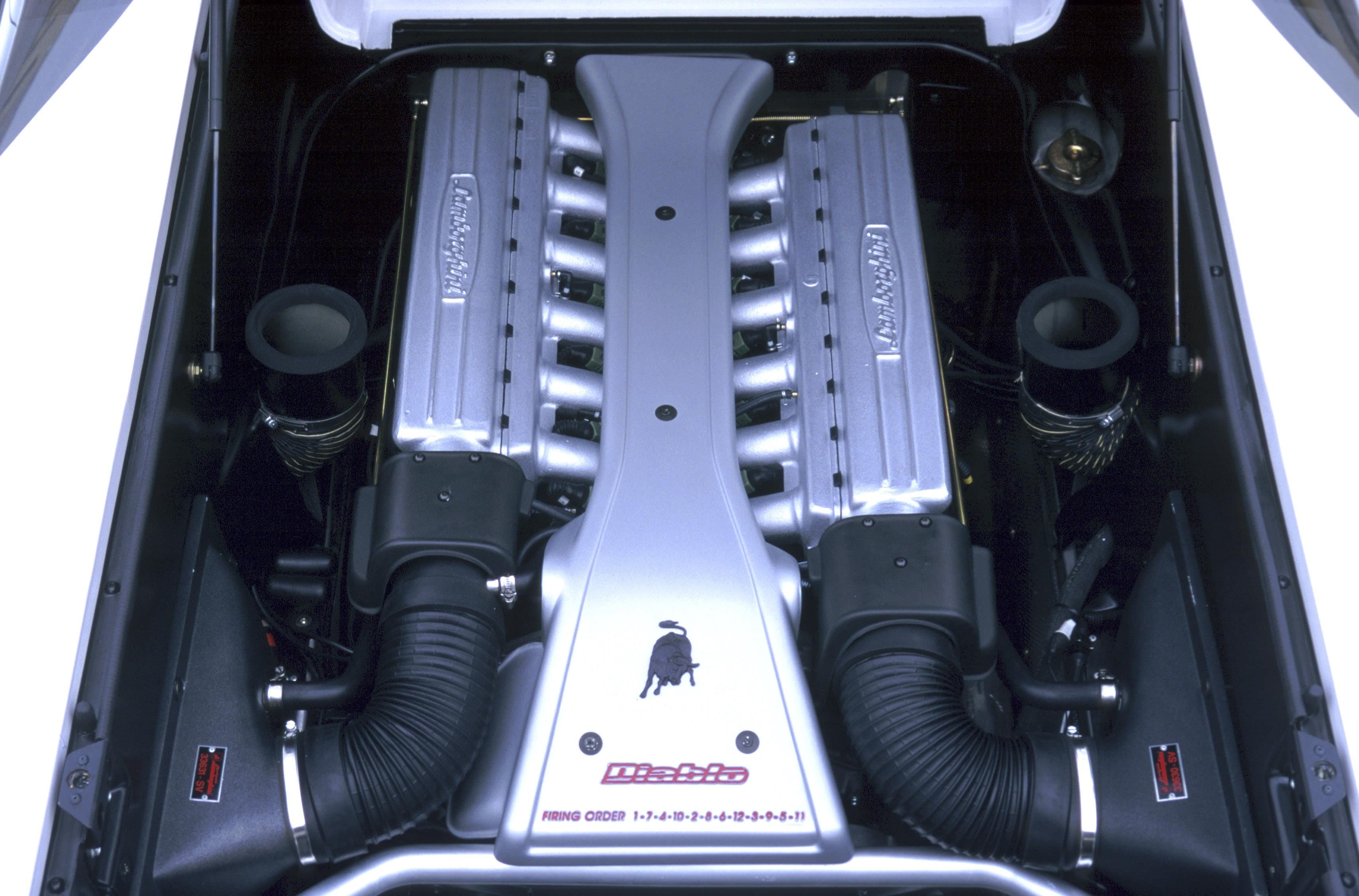 Lamborghini Diablo At 35: How The 1990S Speed King Built The Brand We Know Today 7 Top-down view of the lamborghini diablo v12 engine showing symmetrical intake manifolds and lamborghini branding on valve covers