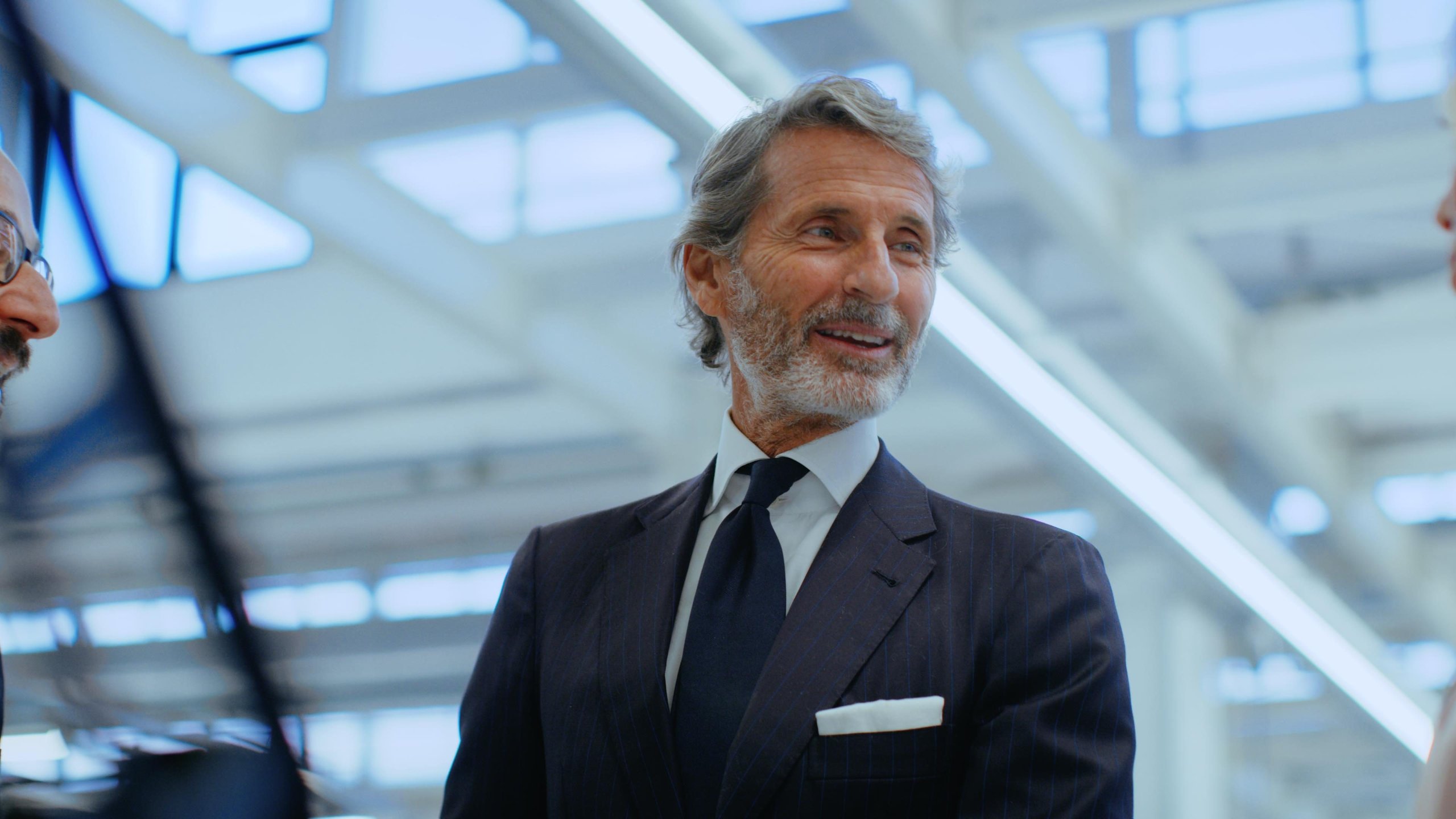 Portrait of stephan winkelmann, ceo of automobili lamborghini, in a modern indoor setting