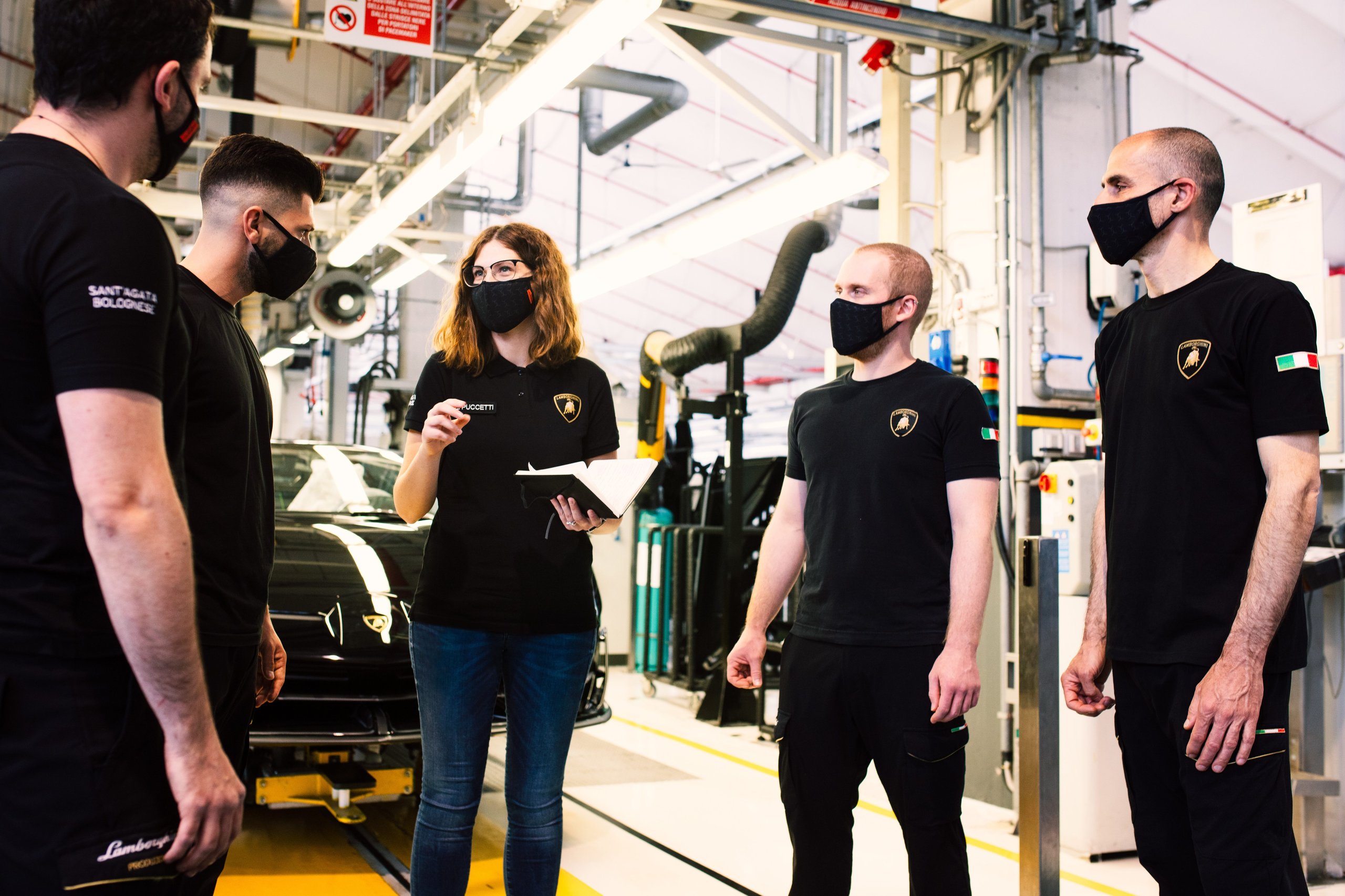 Inside Lamborghini'S Workforce Strategy: Why Dad Coaching And Reverse Mentoring Matter For Future Supercars 5 A group of five lamborghini employees including a female leader in a factory setting with a huracan
