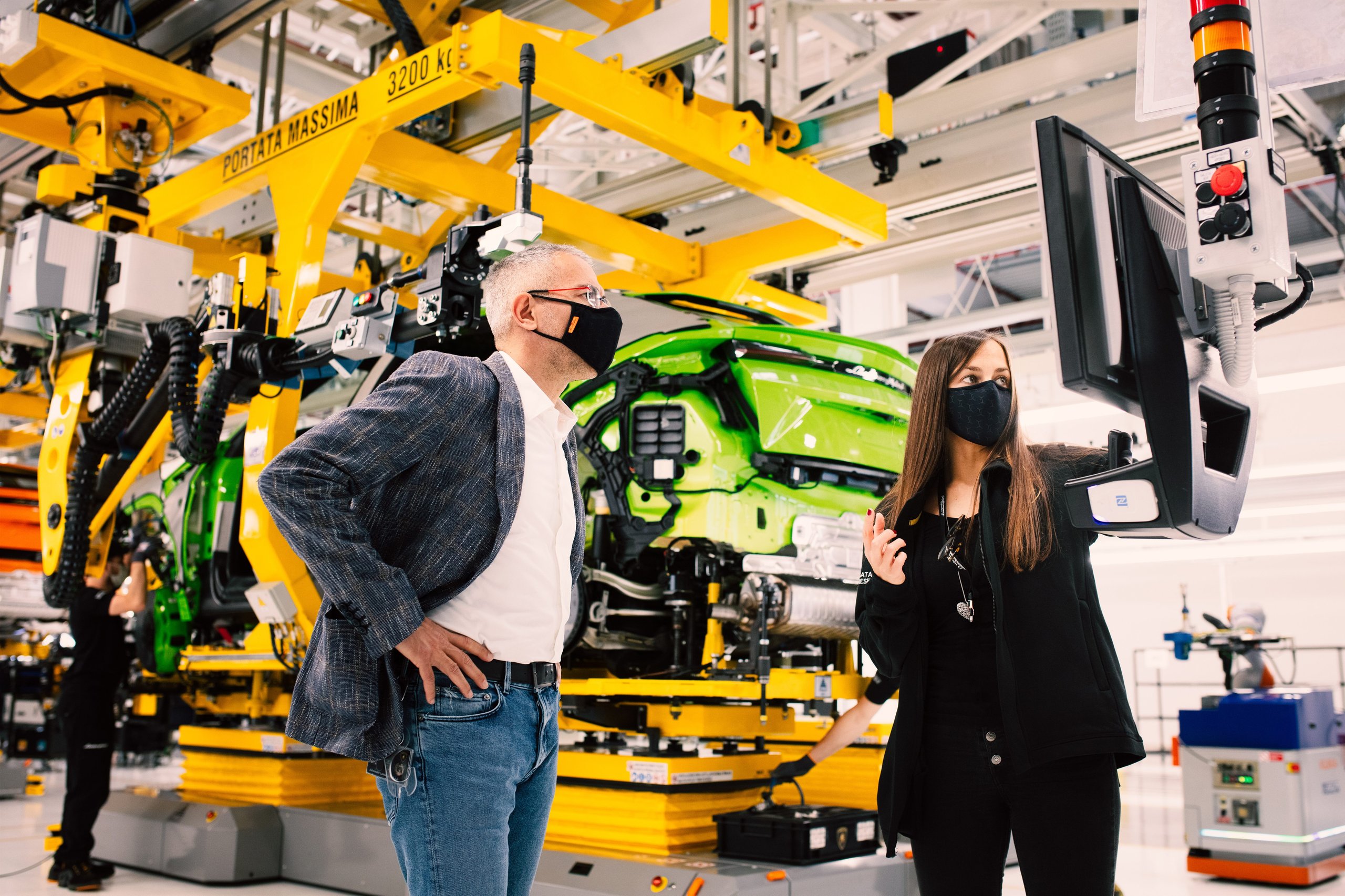 Inside Lamborghini'S Workforce Strategy: Why Dad Coaching And Reverse Mentoring Matter For Future Supercars 9 Two lamborghini employees observing a partially assembled green urus on the assembly line