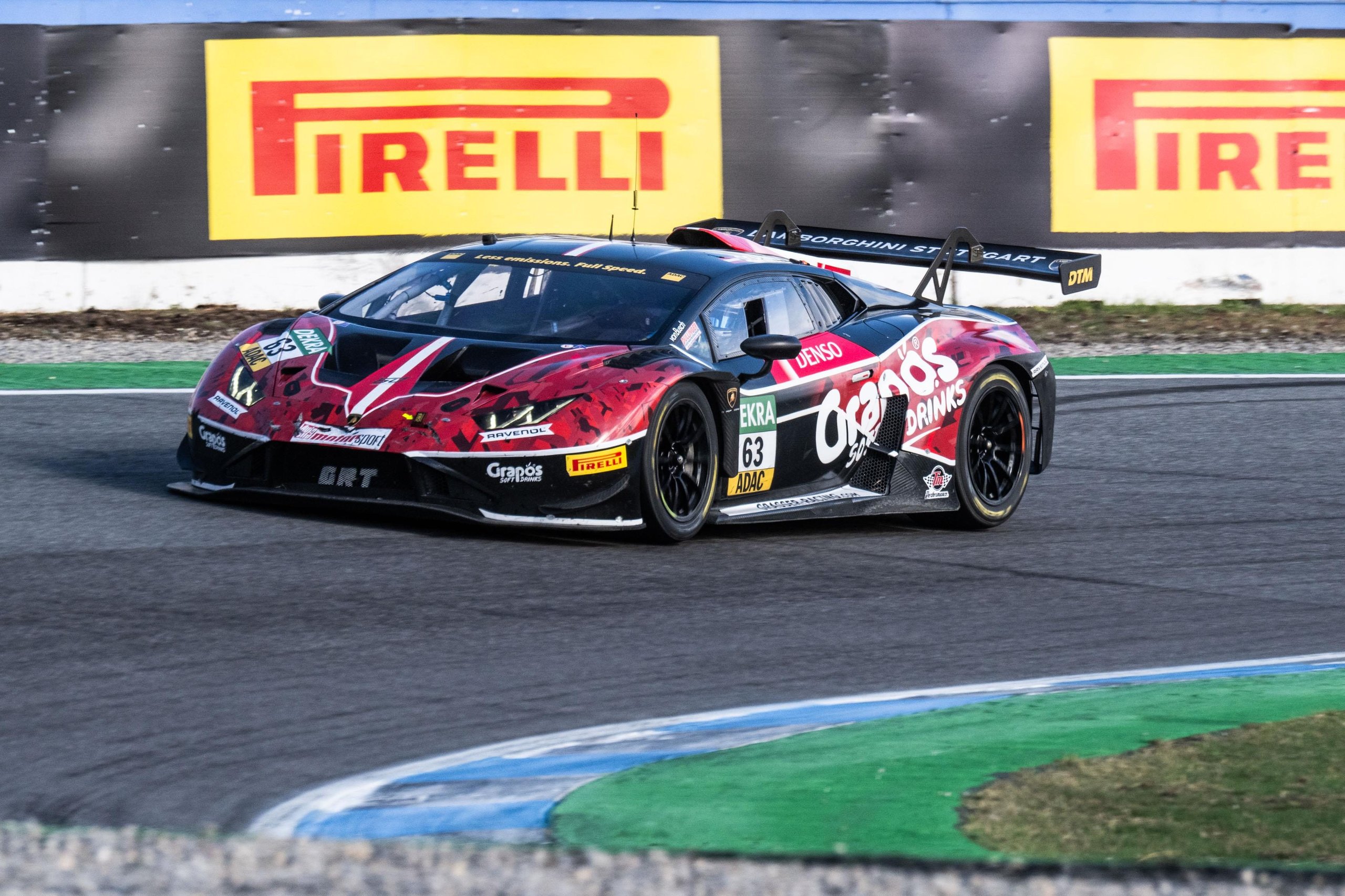 Five Wins, One Near-Miss Title: How The Huracán Gt3 Evo2 Delivered Lamborghini'S Best Dtm Season Yet 5 Red and black lamborghini huracán gt3 evo2 number 63 from grasser racing team cornering on track with pirelli banner visible