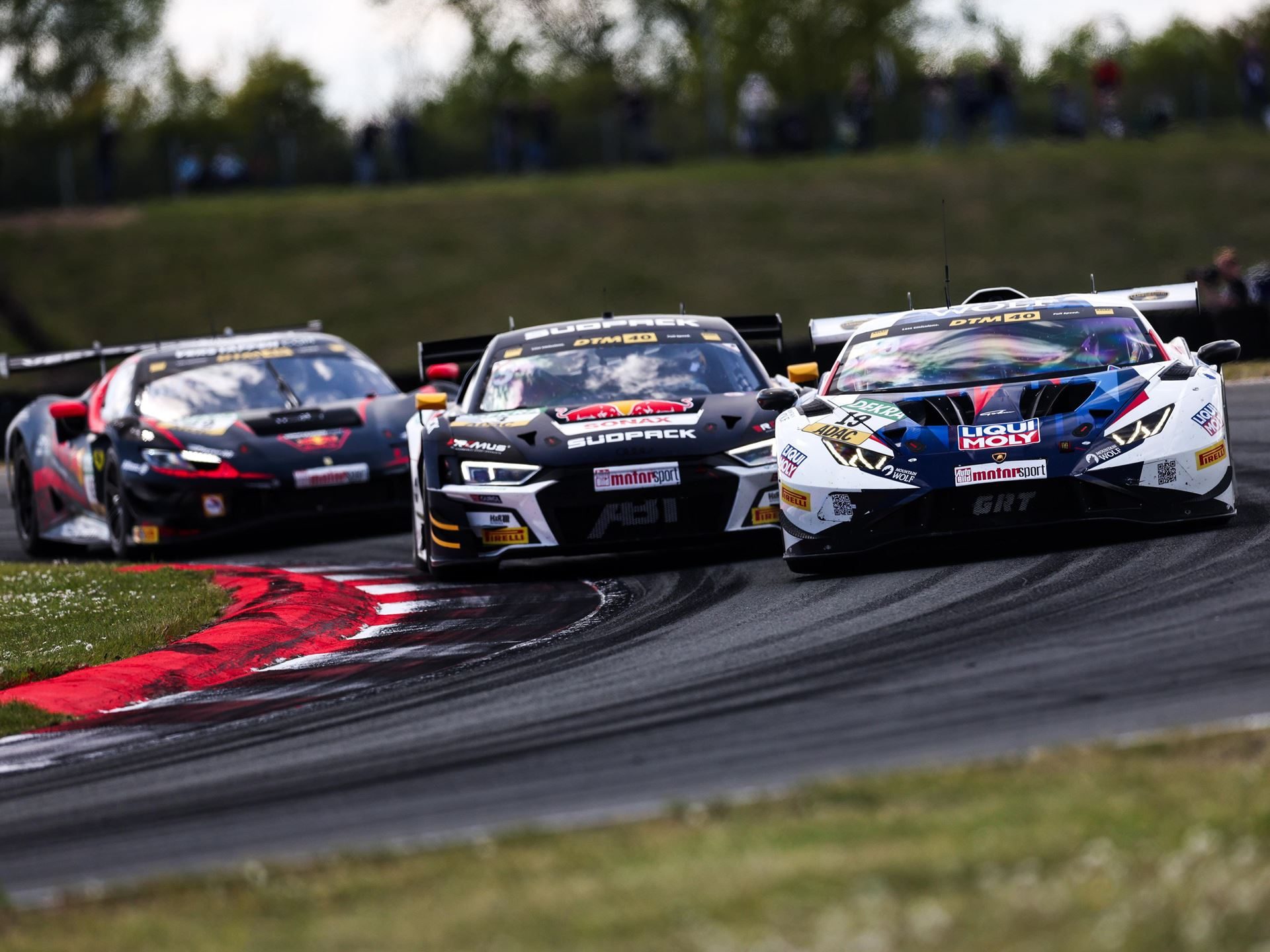 Engstler'S Three-Tenths Margin At Oschersleben Reveals Why The Huracán Gt3 Evo2 Still Bites 3 Lamborghini huracán gt3 evo2 #19 leading two rival dtm cars through a corner at oschersleben