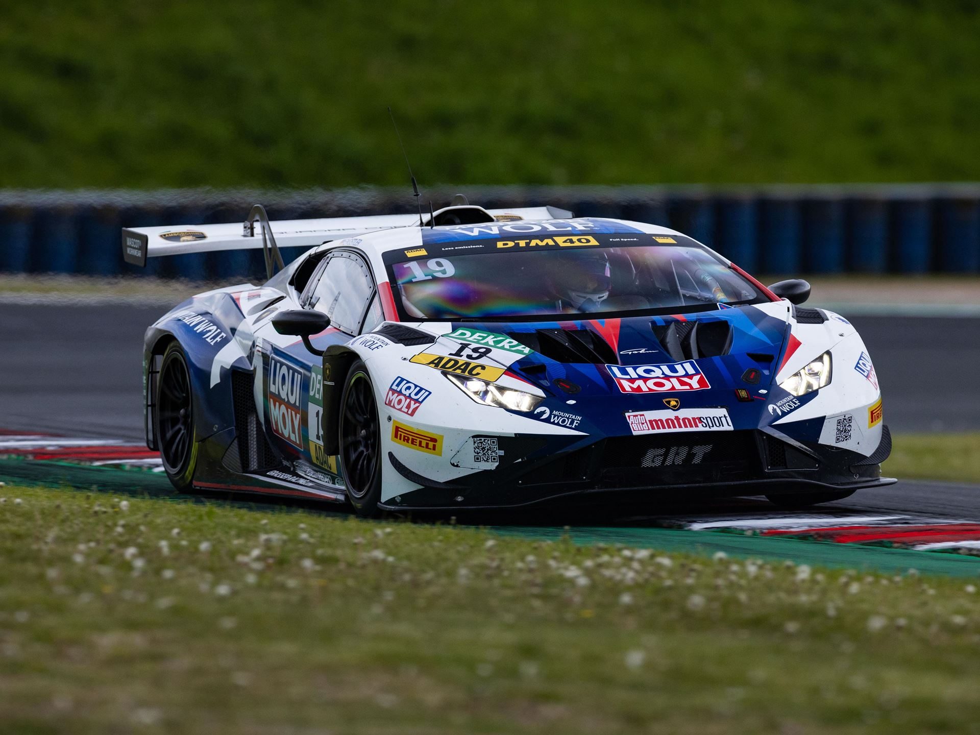 Engstler'S Three-Tenths Margin At Oschersleben Reveals Why The Huracán Gt3 Evo2 Still Bites 9 Close action shot of engstler's #19 lamborghini huracán gt3 evo2 at speed with debris visible