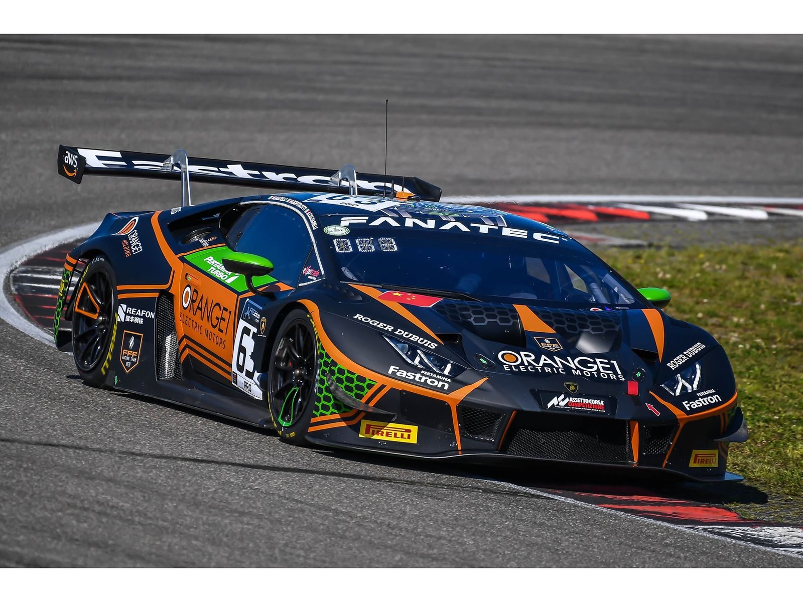 The #63 Orange 1 FFF Racing Lamborghini Huracán GT3 Evo in black and orange livery navigating a turn at the Nürburgring