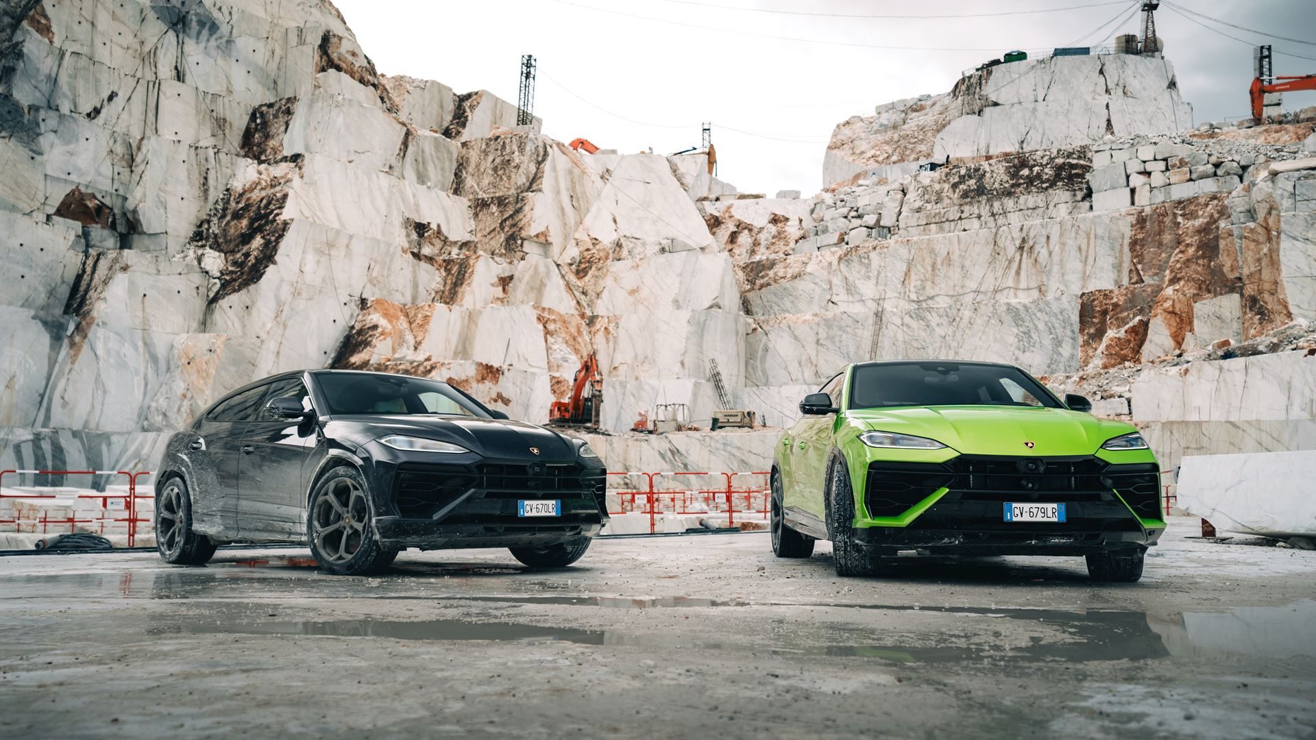 Two lamborghini urus suvs parked in an italian marble quarry during an esperienza terra event