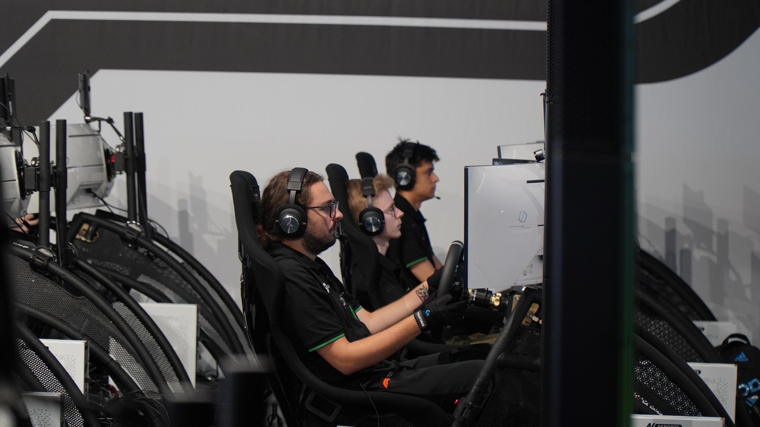 Dario Iemmulo Wins Lamborghini'S European Esports Finals, Earns Shot At Factory Driver Seat 5 Three participants wearing headphones and focused intently on racing simulators during the real race european finals