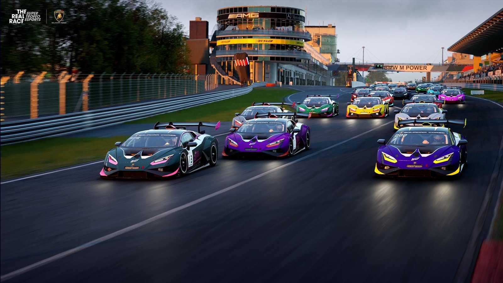 A pack of Lamborghini Huracán GT3 EVO race cars in various liveries racing down a virtual track during The Real Race esports competition