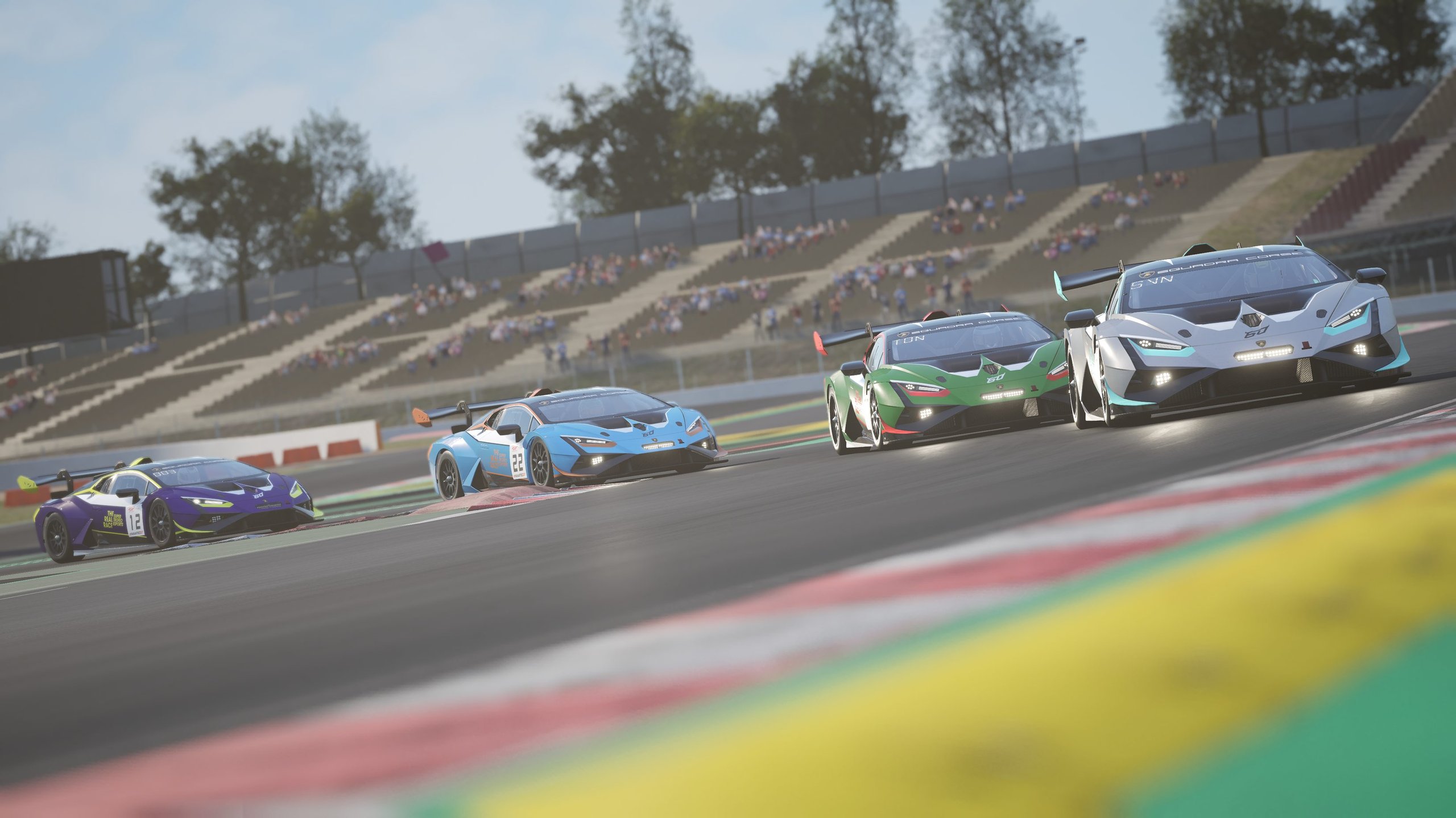 How Lamborghini'S 2023 Real Race Turned Sim Racers Into Factory Drivers 3 Four lamborghini huracán super trofeo evo2 race cars in white, green, blue, and purple liveries racing on a circuit