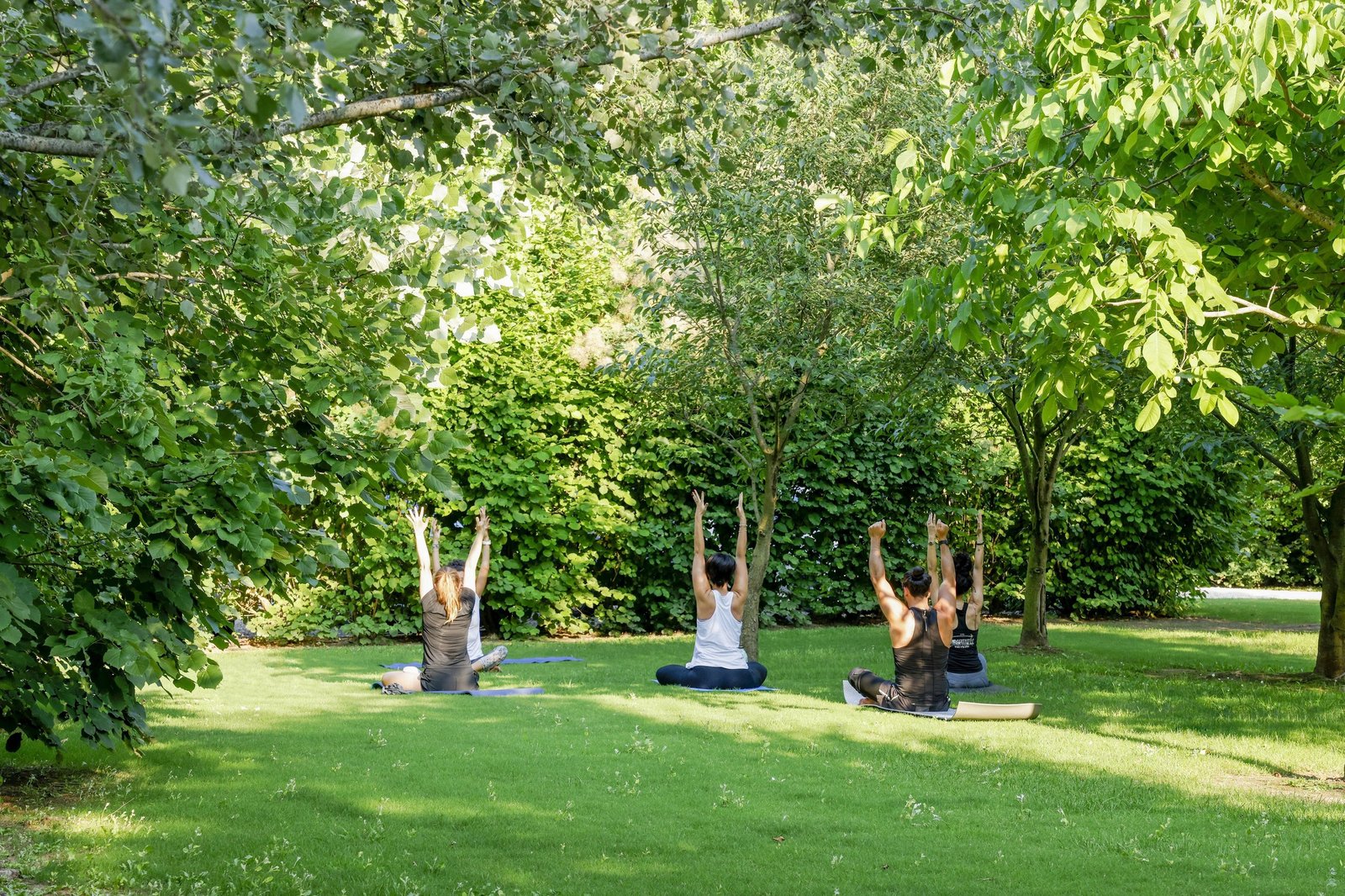 Lamborghini employees participating in an outdoor yoga session as part of the FEELOSOPHY well-being program