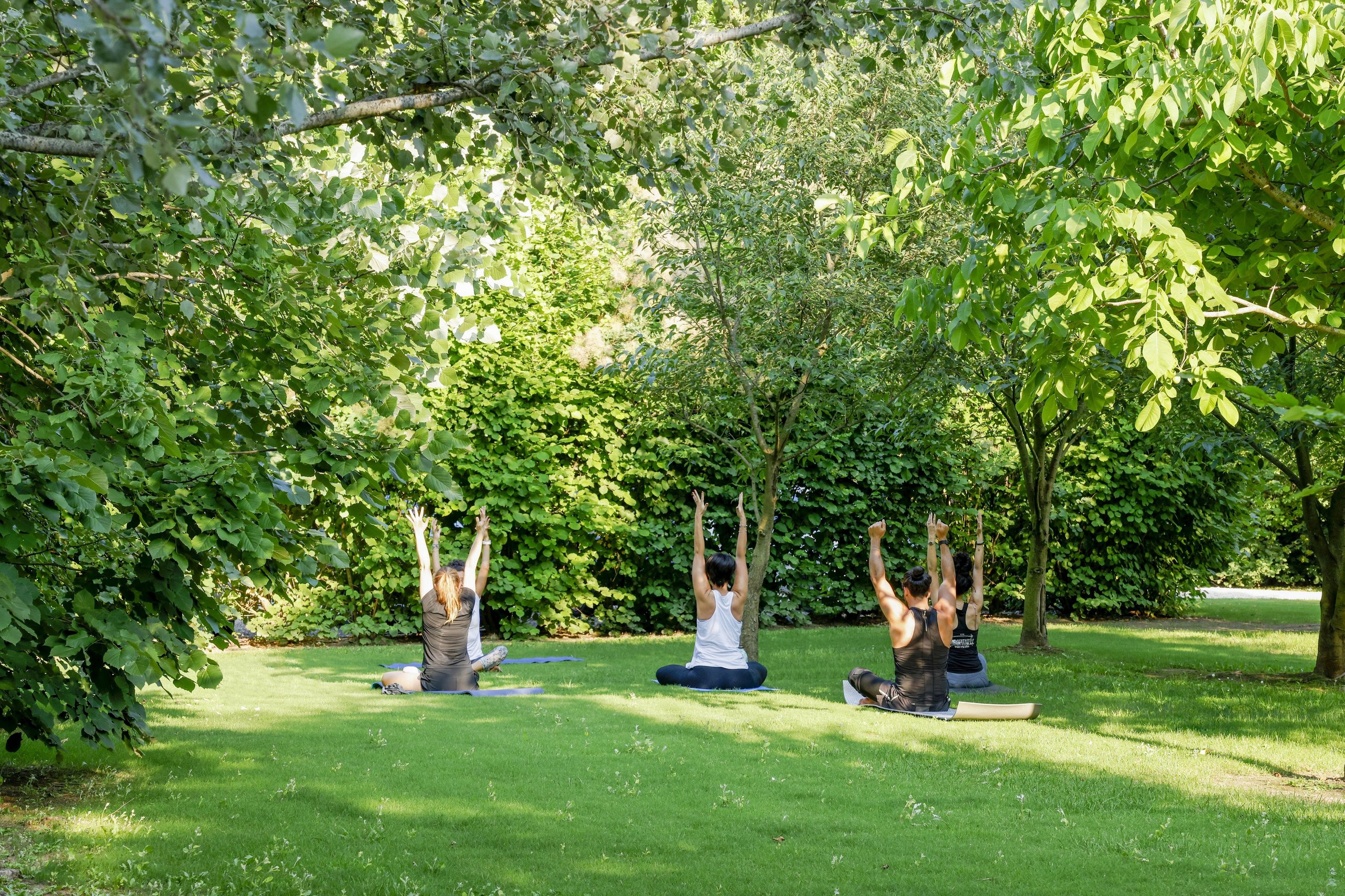 Lamborghini employees participating in an outdoor yoga session as part of the feelosophy well-being program