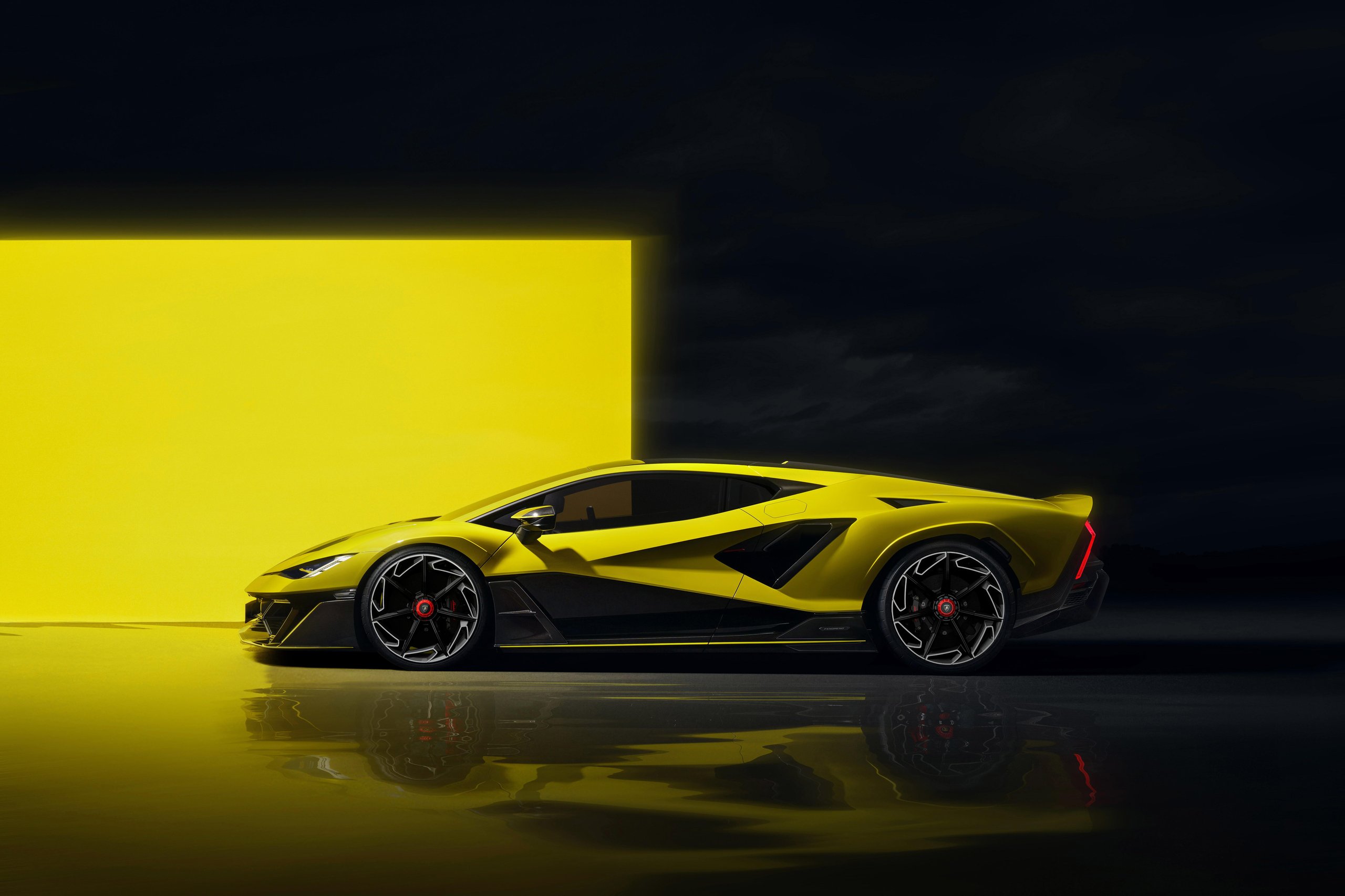 Yellow lamborghini fenomeno side profile showing elongated aerodynamic silhouette and turbine-design single-nut wheels