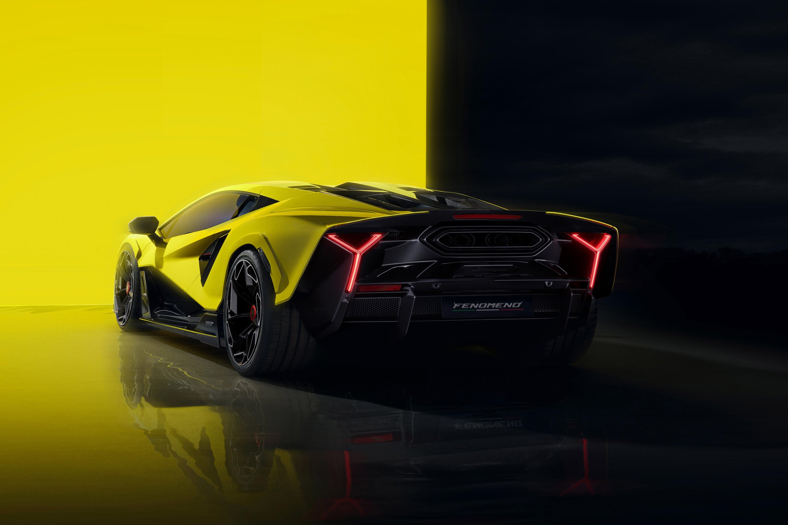 Rear three-quarter view of the yellow lamborghini fenomeno showing y-shaped taillights and aggressive carbon fiber diffuser