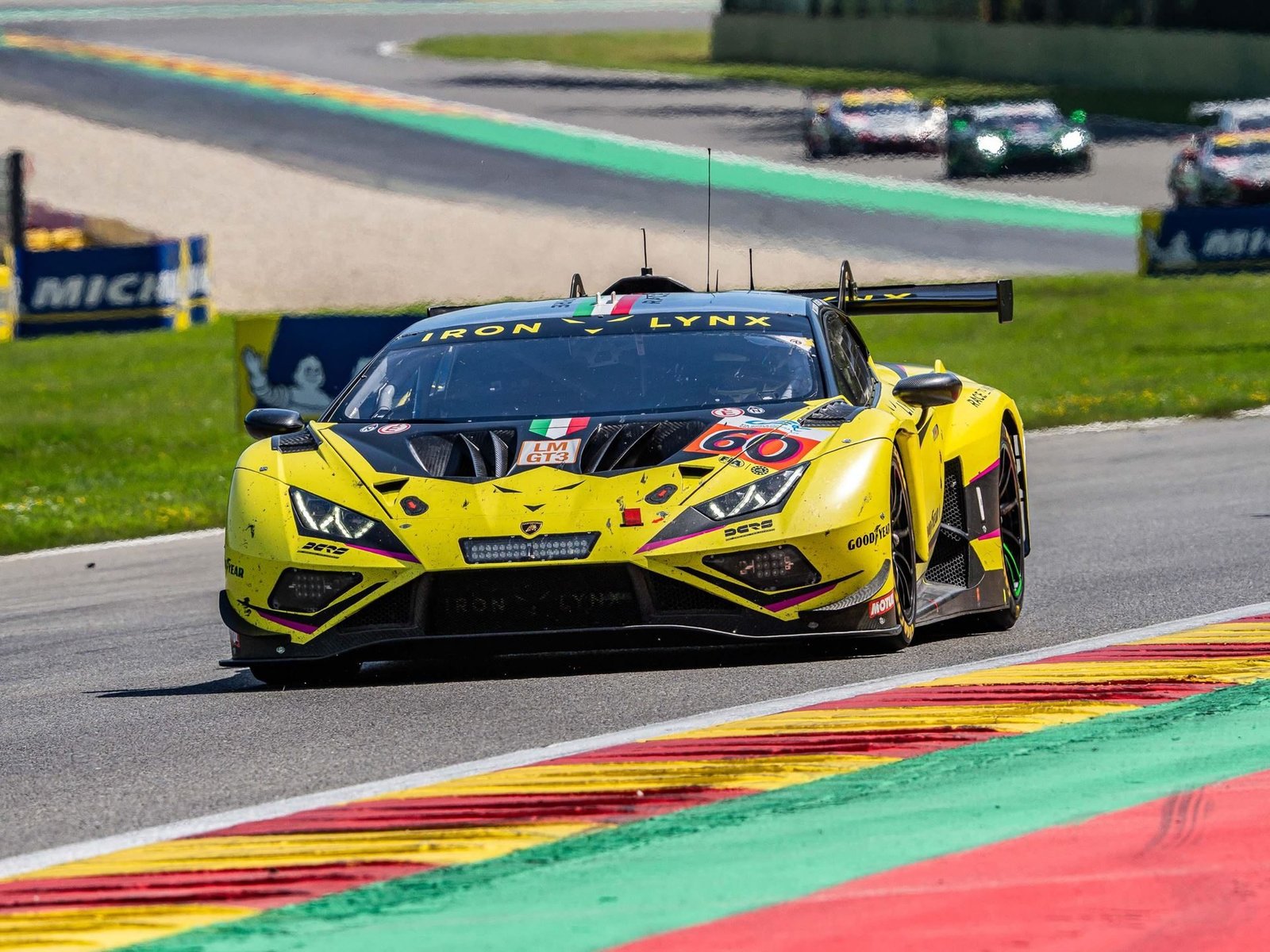 The No. 60 Lamborghini Huracán GT3 EVO2 in yellow and black livery racing at Spa-Francorchamps