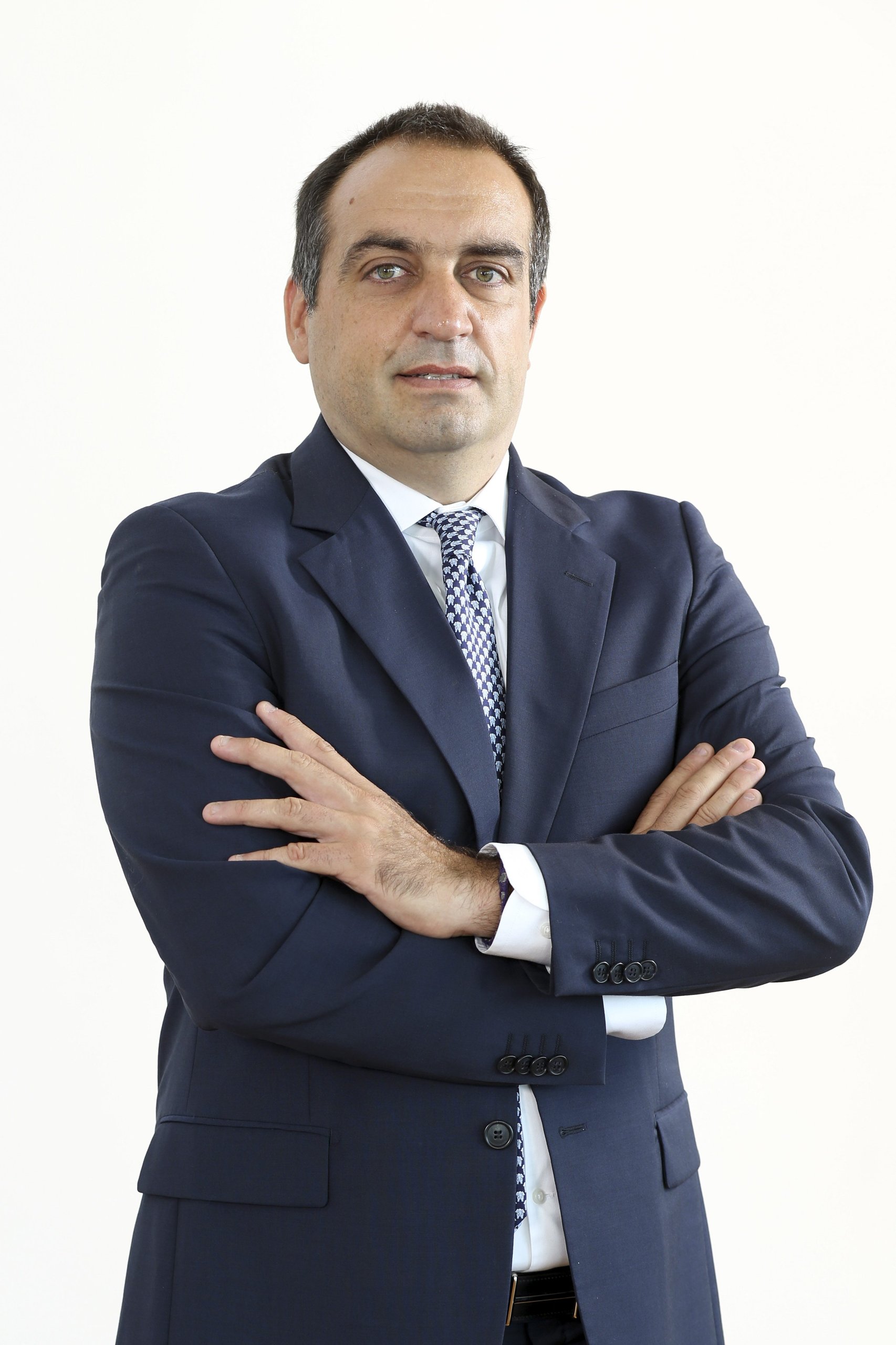Lamborghini Puts One Executive In Charge Of Both Marketing And Sales, Hires Bugatti'S Comms Chief: Why It Matters 7 Studio portrait of tim bravo in a dark suit and patterned tie against a white background