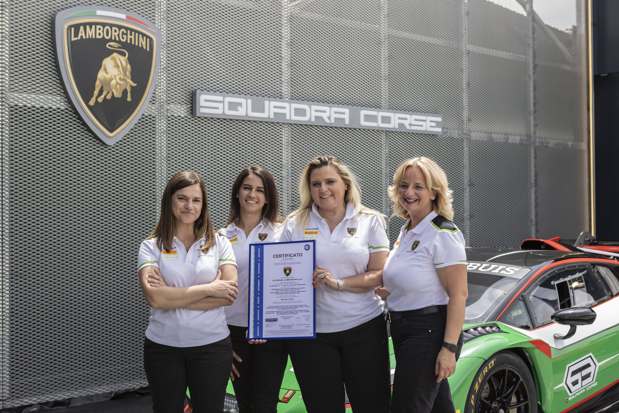 Lamborghini'S Gender Equality Certification Puts Sant'Agata Ahead Of Most Rivals, But What Does It Actually Mean? 9 Four women in lamborghini and pirelli polo shirts holding a certificate in front of a squadra corse sign and huracan super trofeo race car