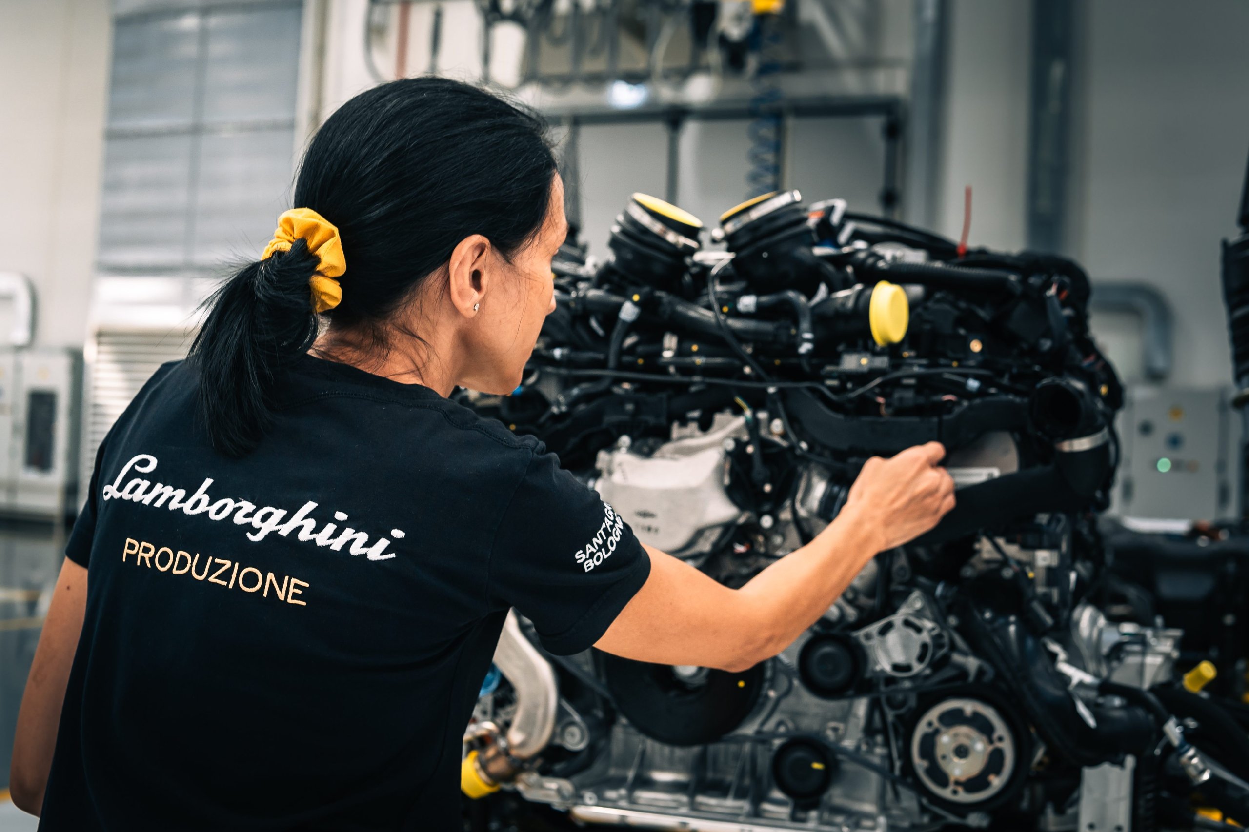 Lamborghini'S Gender Equality Certification Puts Sant'Agata Ahead Of Most Rivals, But What Does It Actually Mean? 7 Female lamborghini production worker inspecting a complex engine assembly on the factory floor