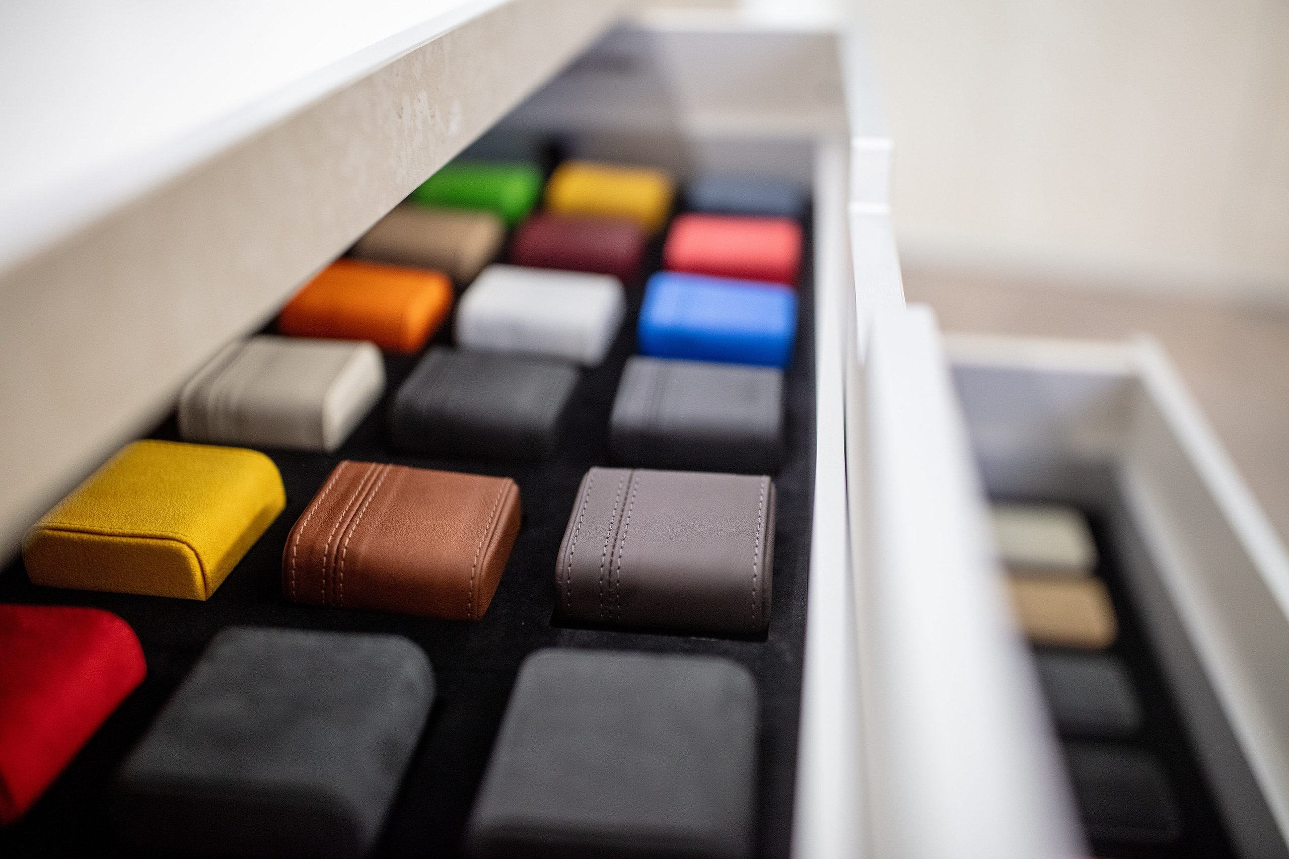 Lamborghini Geneva Celebrates 20 Years With A Showroom Built For The Brand'S Next Chapter 5 Drawer filled with neatly arranged color and material samples for lamborghini ad personam customization