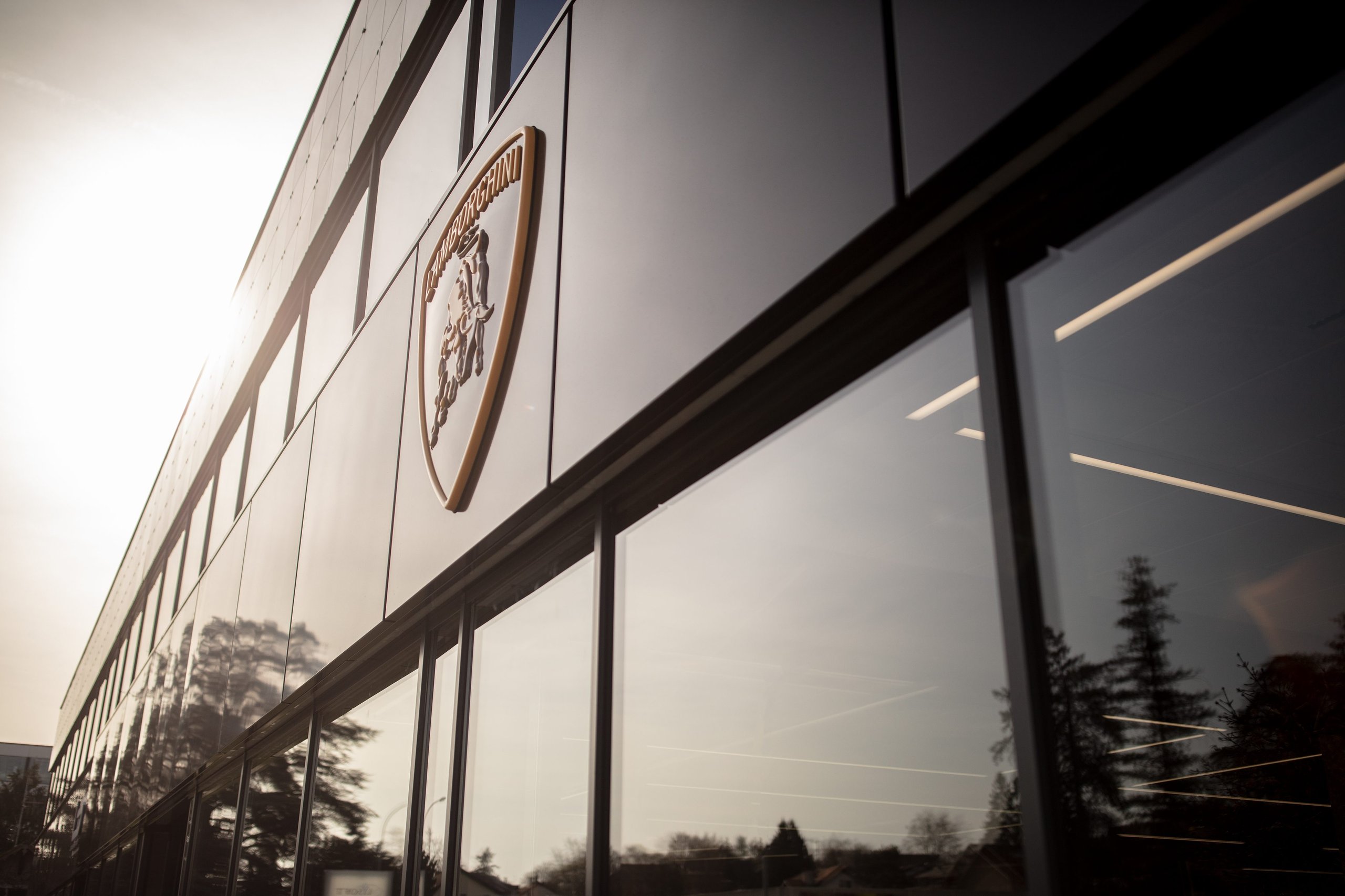 Lamborghini Geneva Celebrates 20 Years With A Showroom Built For The Brand'S Next Chapter 9 Exterior of the modern lamborghini geneva showroom building with prominent shield logo on the facade