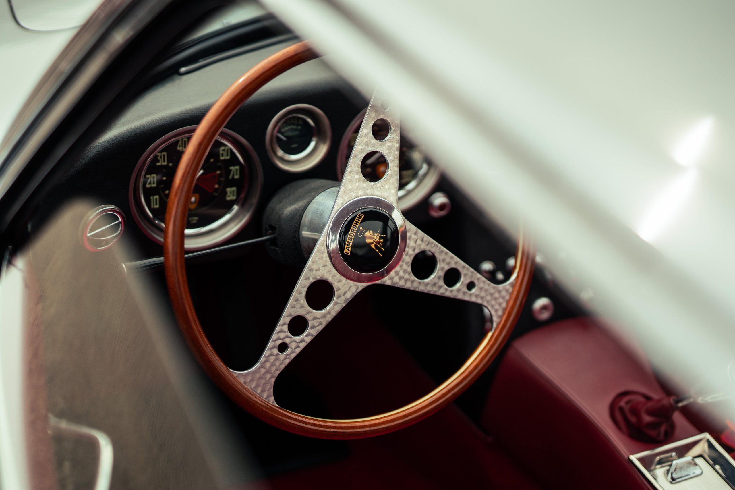 How Lamborghini Turned Italy'S Roads Into A Rolling Museum For Its 60Th Anniversary 7 Close-up of the wooden steering wheel and vintage dashboard of a lamborghini 350 gt showing classic gauges and craftsmanship
