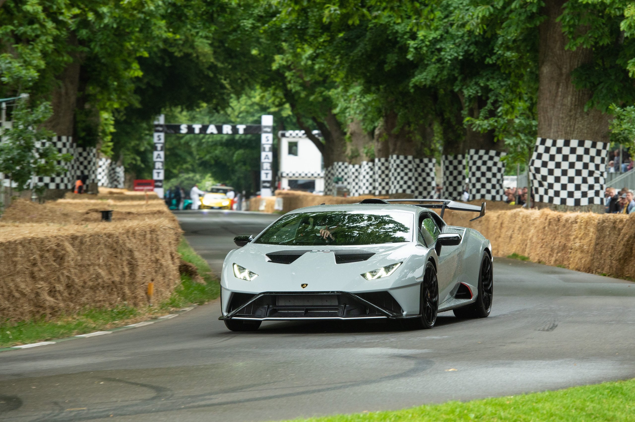 Lamborghini'S Goodwood Farewell: Why Sant'Agata Staged A Last Call For Naturally-Aspirated Power In Front Of 450 Owners 9 Grey lamborghini huracán sto at speed on the tree-lined goodwood hill climb past the start banner