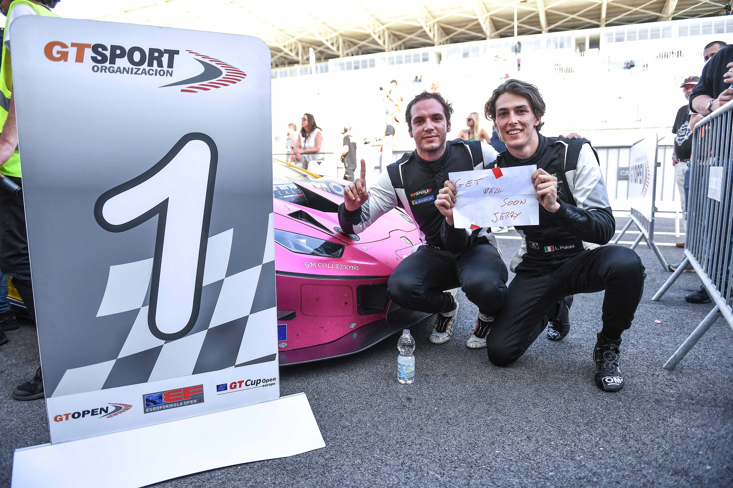 Oregon Team'S Clean Sweep At Estoril And Bortolotti'S Dtm Lead Signal The Huracán Gt3 Evo Still Owns Gt Racing 3 Oregon team drivers kneeling beside the pink lamborghini huracán gt3 evo holding a number 1 board and a get well soon jerry sign after their double victory at estoril
