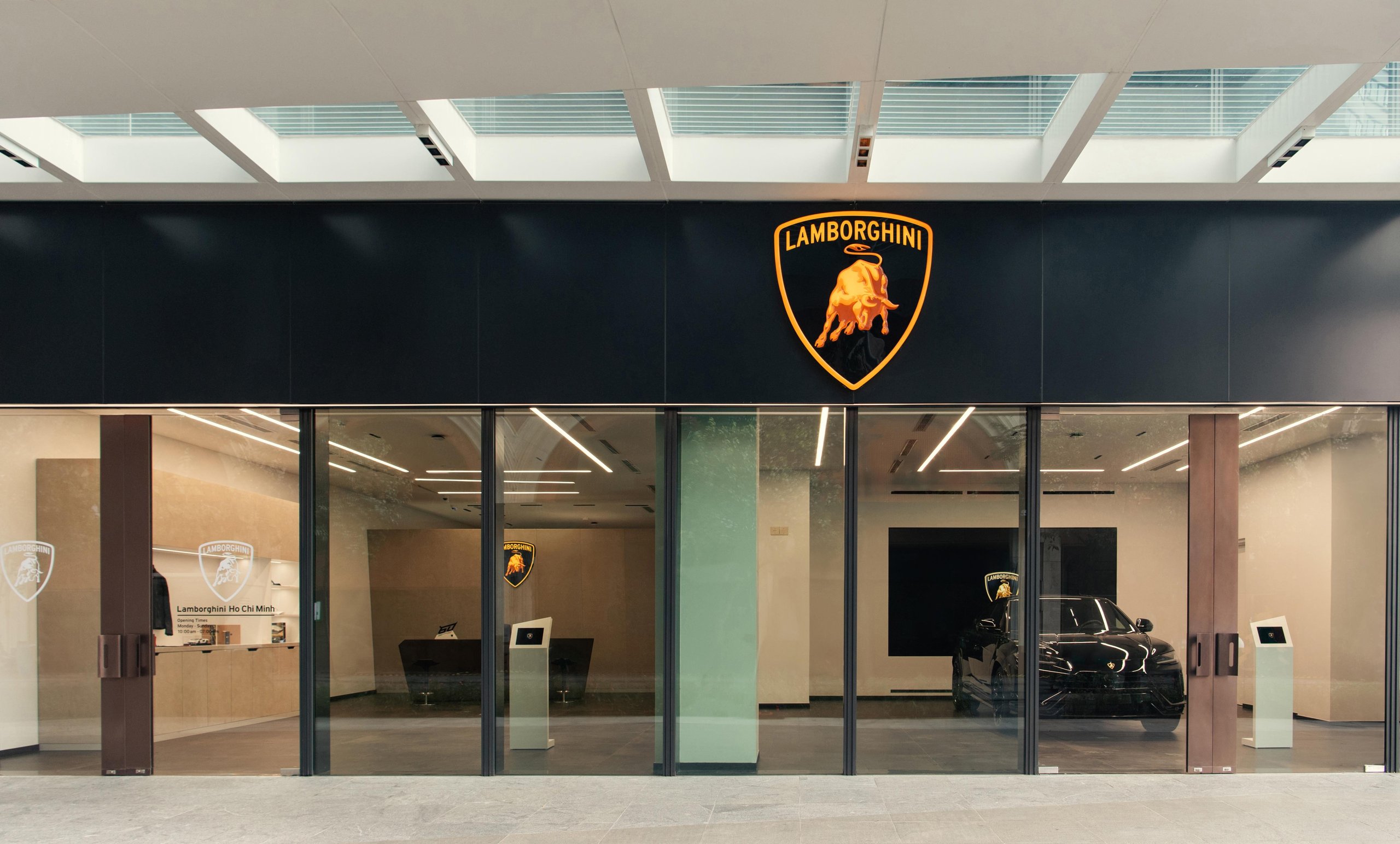 Lamborghini Plants Its Flag In Vietnam With A Ho Chi Minh City Showroom That Doubles As A 60Th Anniversary Statement 5 The front facade of the lamborghini ho chi minh city dealership showing the illuminated lamborghini shield logo and a black urus visible through the glass