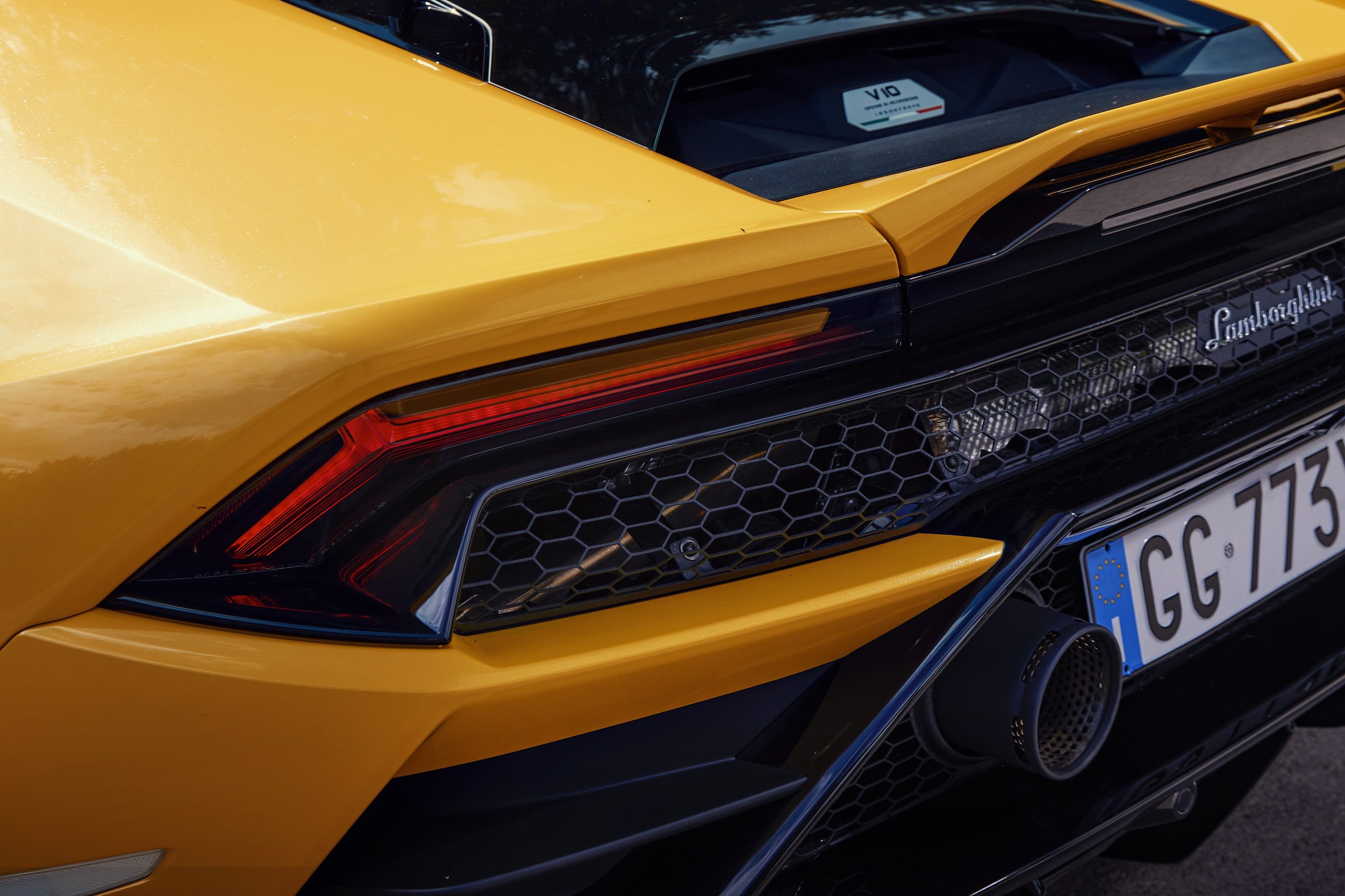 Goodwood 2022: How Lamborghini Used The Duke Of Richmond And Four Cars To Stage A Love Letter To Naturally Aspirated Power 7 Close-up of the rear section of a yellow lamborghini huracán tecnica showing hexagonal grille, led taillights, and dual exhaust tips