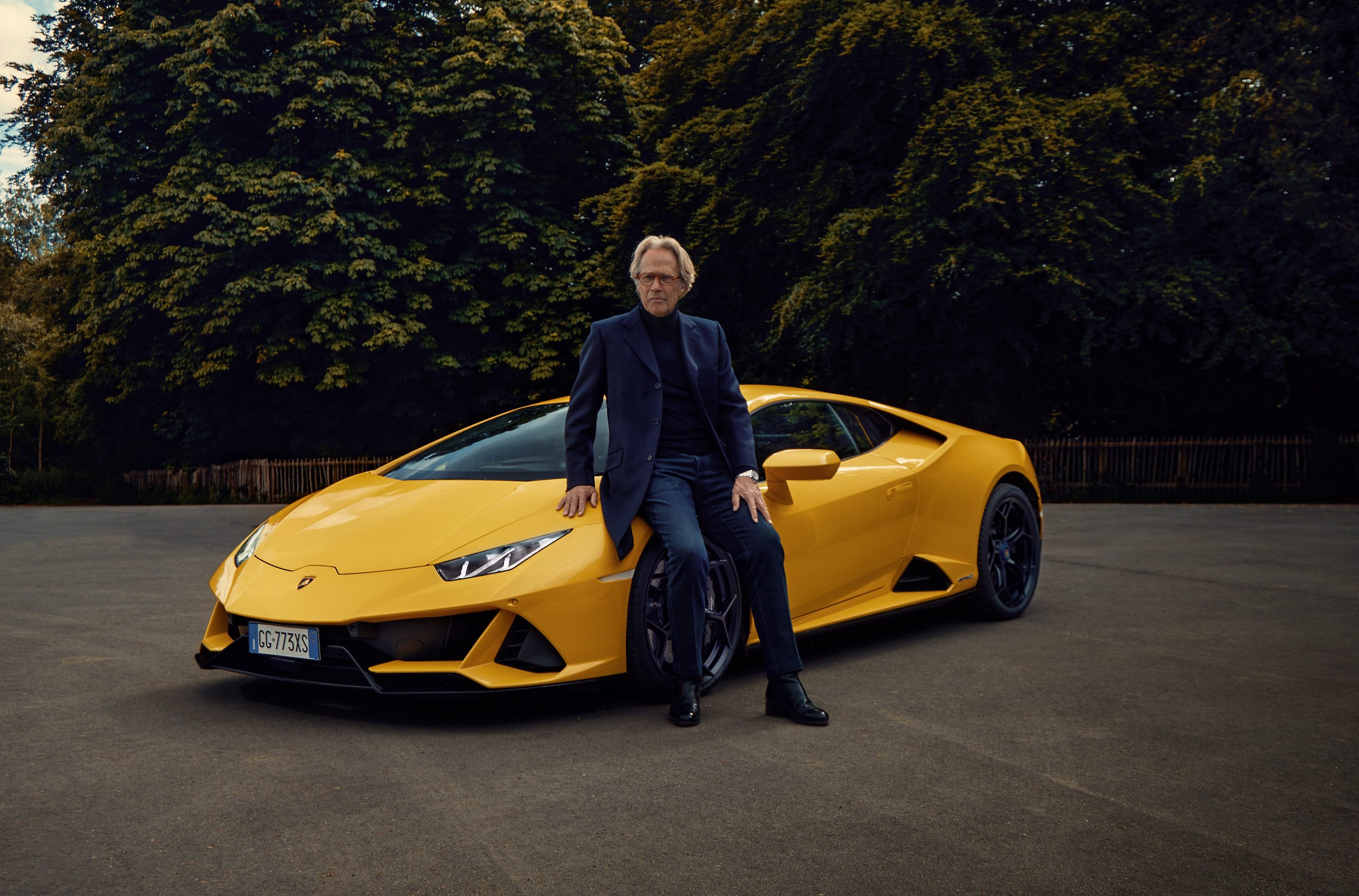 Goodwood 2022: How Lamborghini Used The Duke Of Richmond And Four Cars To Stage A Love Letter To Naturally Aspirated Power 9 The duke of richmond sitting casually on the front wheel of a yellow lamborghini huracán tecnica with green trees in the background
