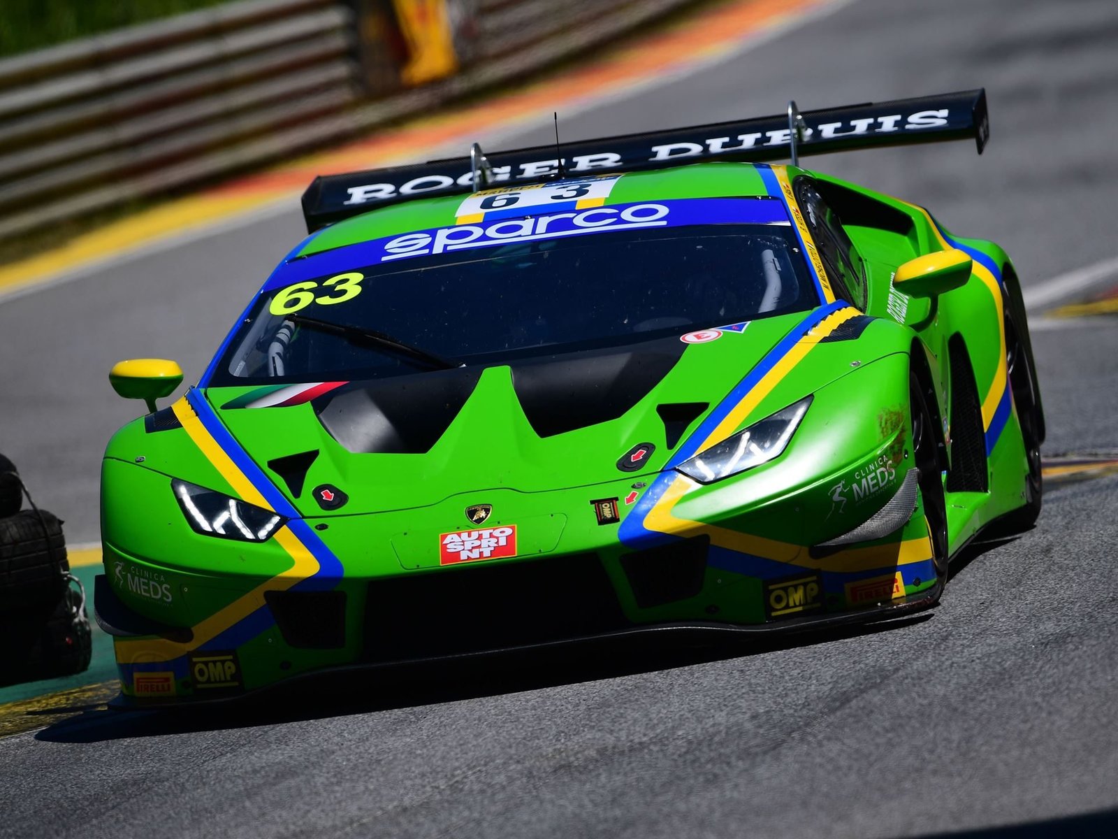 Lamborghini Huracán GT3 number 63 at speed showing front splitter, canards, and large rear wing