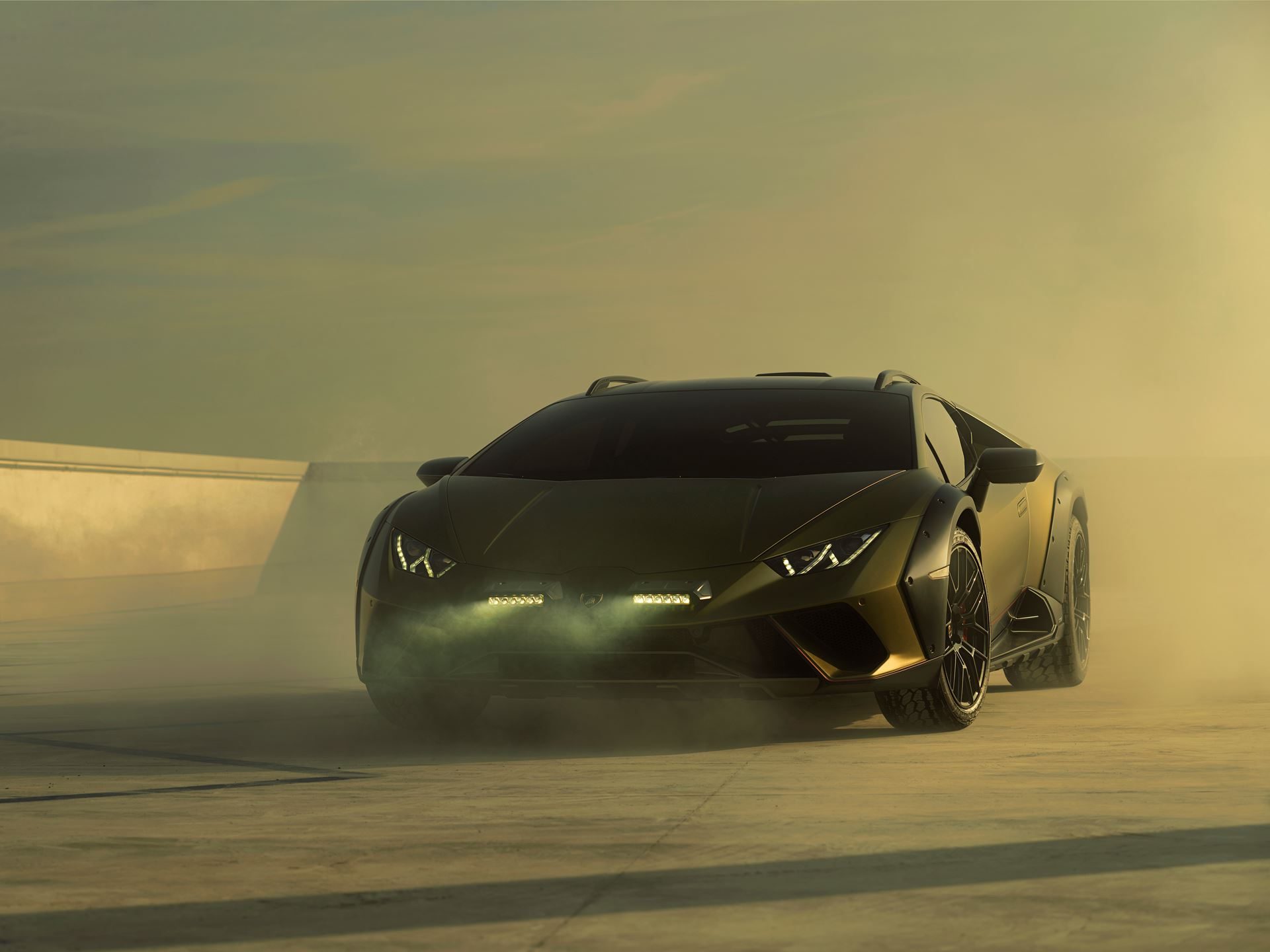 Huracán Sterrato: How Lamborghini'S V10 Off-Road Gamble Rewrites The Supercar Playbook 3 Low-angle shot of the lamborghini huracán sterrato emerging from dust with auxiliary lights, roof rails, and raised ride height visible