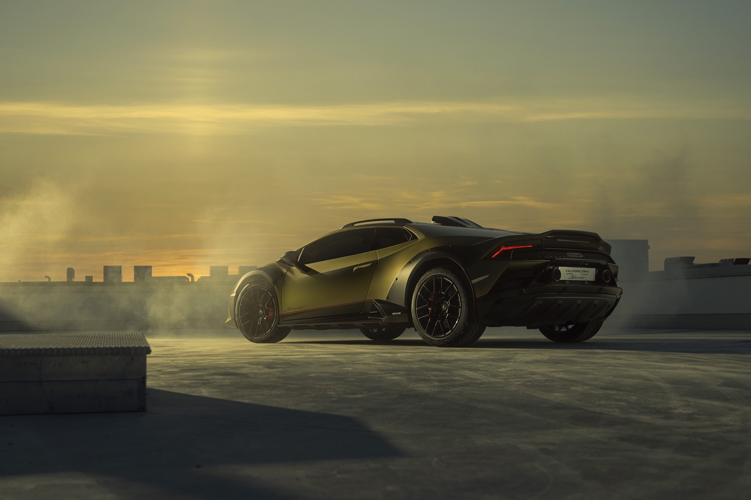 Huracán Sterrato: How Lamborghini'S V10 Off-Road Gamble Rewrites The Supercar Playbook 7 Rear three-quarter view of the lamborghini huracán sterrato showing rear diffuser, dual exhaust, roof rails, and elevated stance against a sunset sky
