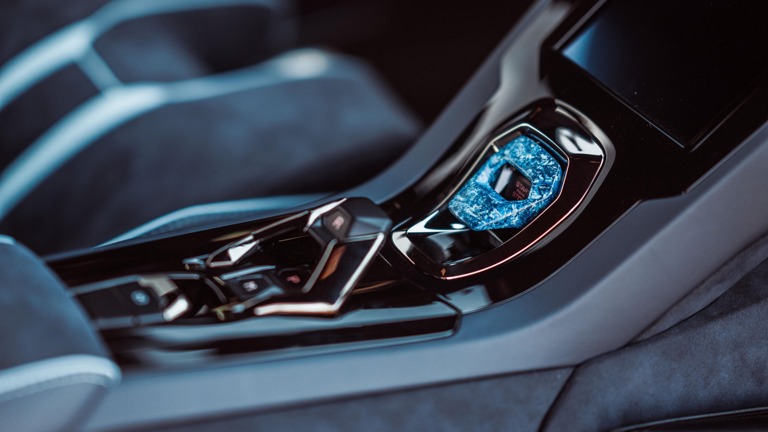 370 Hours Of Blue: How Lamborghini'S Opera Unica Sterrato Turns Paint Into Philosophy 7 Close-up of the opera unica huracán sterrato center console showing the blue-painted starter button cover and glossy black trim