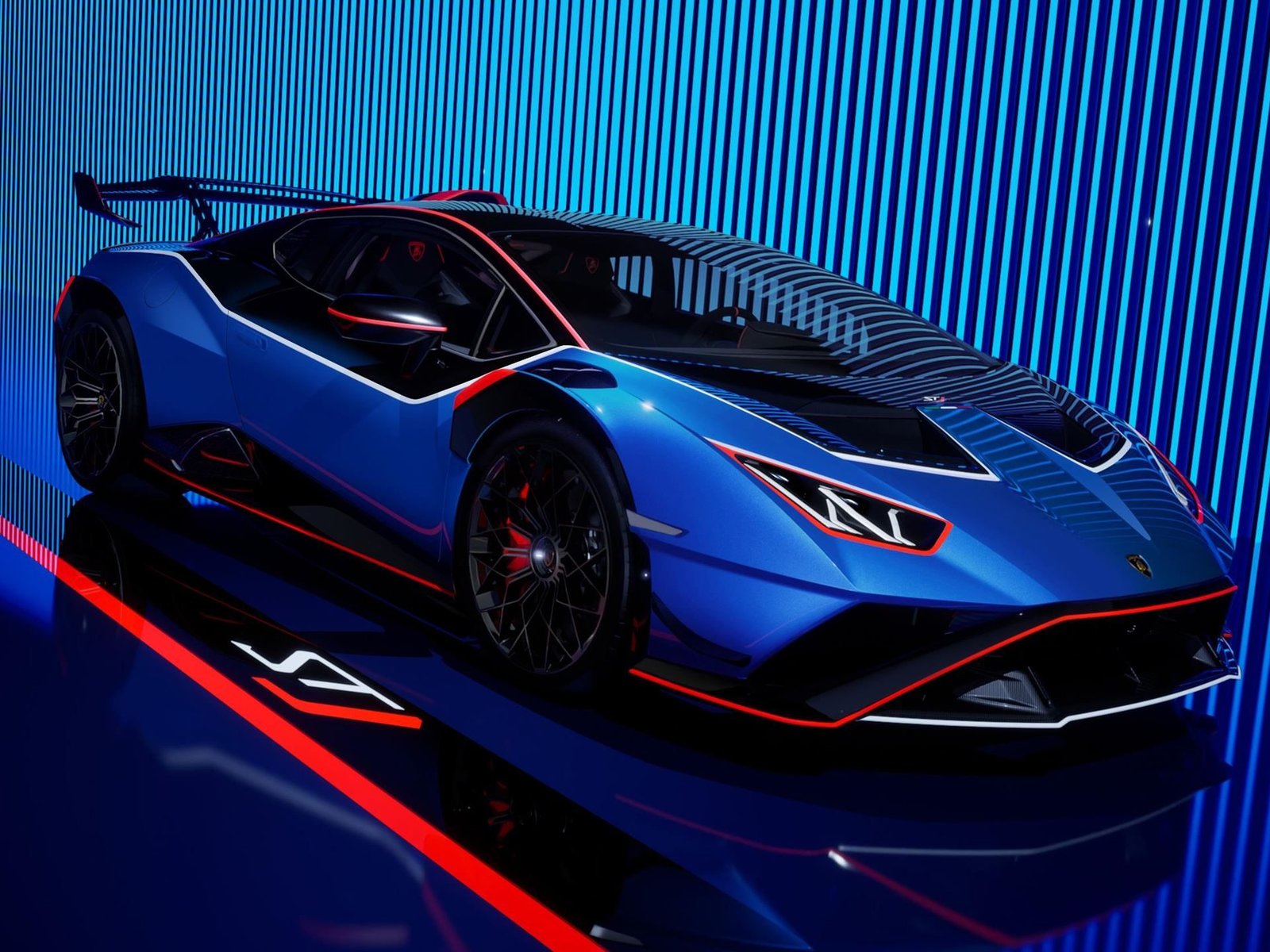 Lamborghini Huracán STJ in Blu Eliadi with red and white racing livery, studio shot showing full profile with rear wing and aerodynamic details